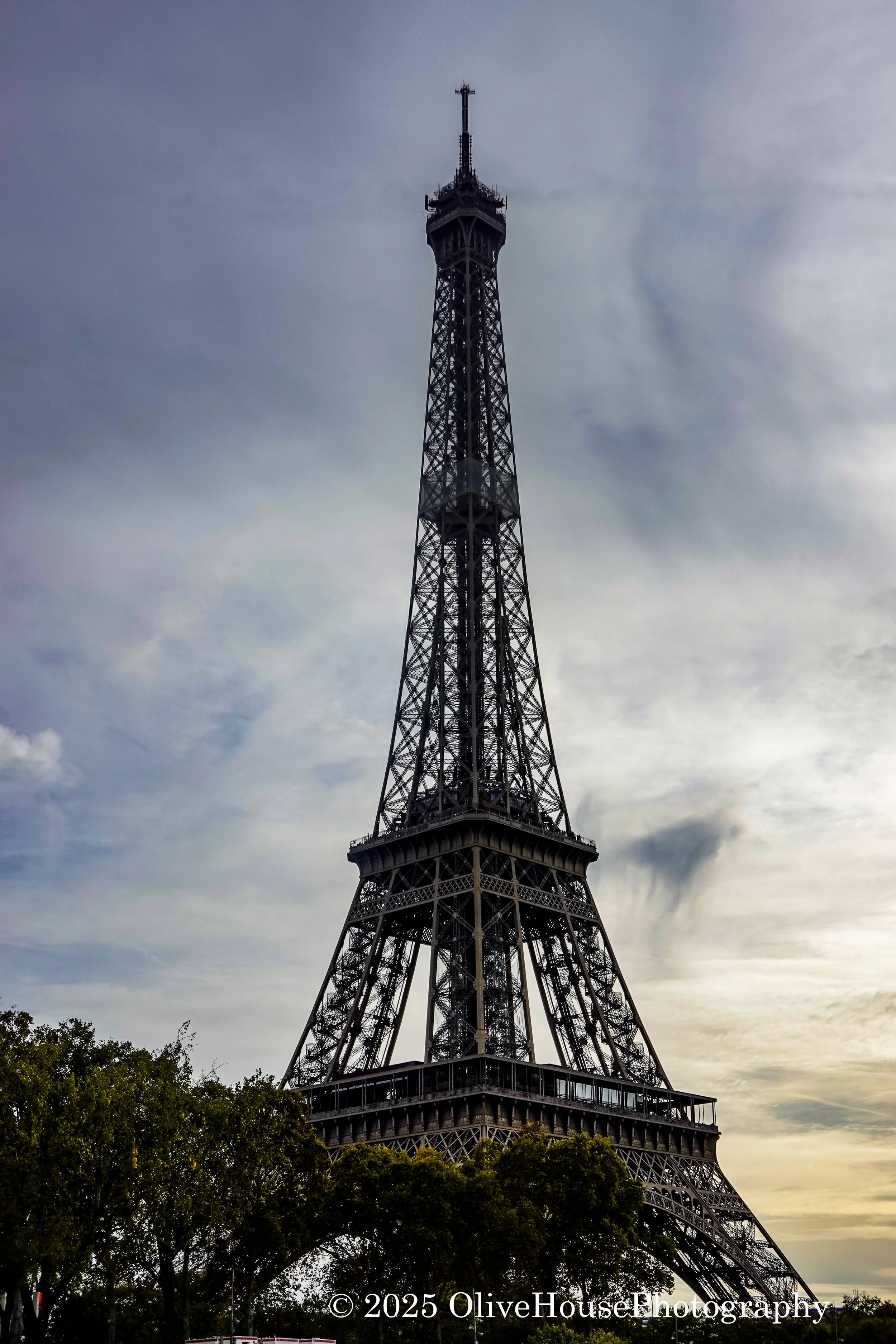 Eiffel Tower, Paris, France at sunset. The image of Eiffel Tower at night is copyrighted, making it illegal to photograph the Tower at night.