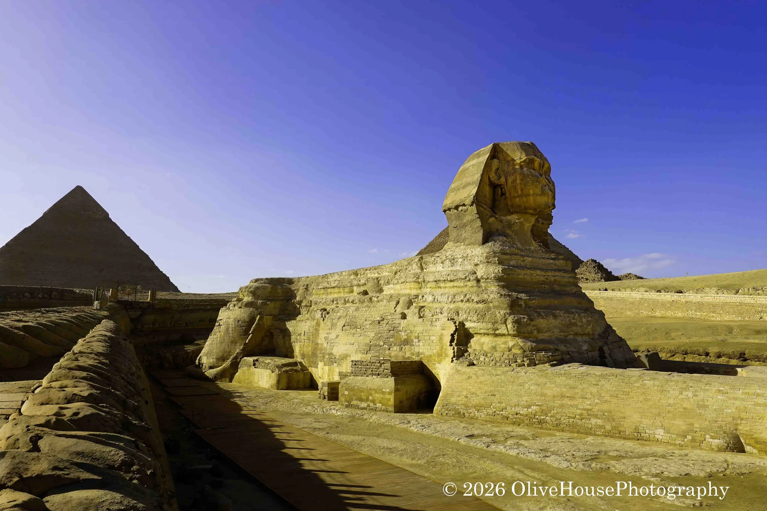 Great Sphinx of Giza located on the Giza Plateau in Egypt, features the body of a lion and the head of a human, believed to represent the Pharaoh Khafre. Constructed around 2500 BC, it is one of the world's largest and oldest monolithic statues, meas