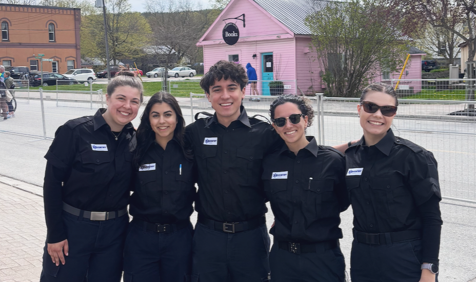 Five Aventry Medical medics in black uniforms standing together outdoors.
