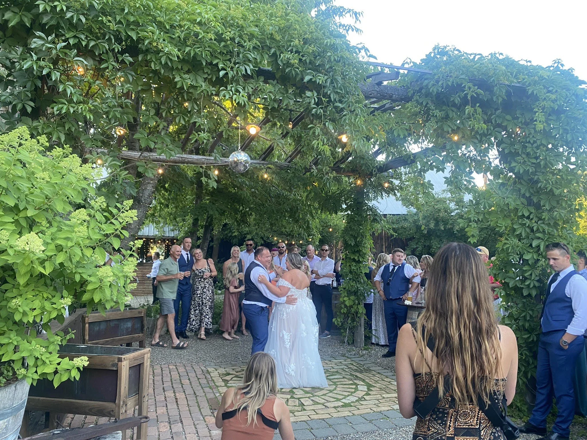 An image of a bride and groom dancing at their outdoor wedding reception at StoneHouse101. StoneHouse101 is an intimate indoor outdoor events venue in Roslyn, Washington, hosting weddings, birthdays, anniversaries, and more near Cle Elum, WA.