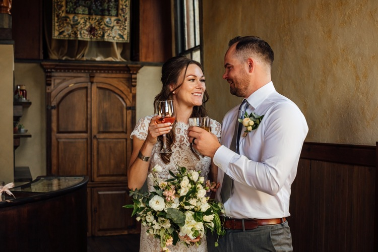 An image of a bride and groom inside historic StoneHouse101. StoneHouse101 is an intimate indoor outdoor events venue in Roslyn, Washington, hosting weddings, birthdays, anniversaries, and more near Cle Elum, WA.