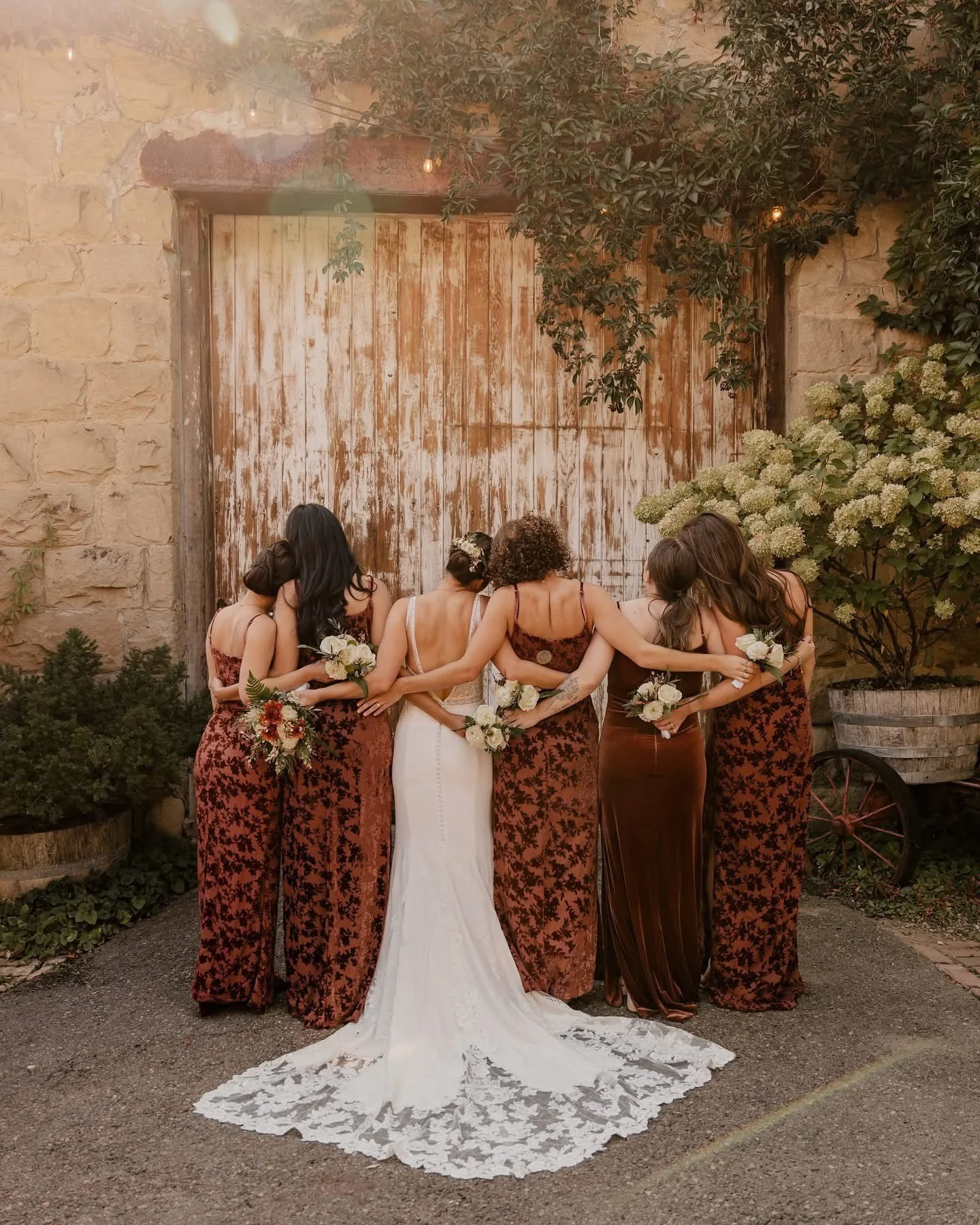 An image of a bridal party hugging for a photo outside of StoneHouse101. StoneHouse101 is an intimate indoor outdoor events venue in Roslyn, Washington, hosting weddings, birthdays, anniversaries, and more near Cle Elum, WA.