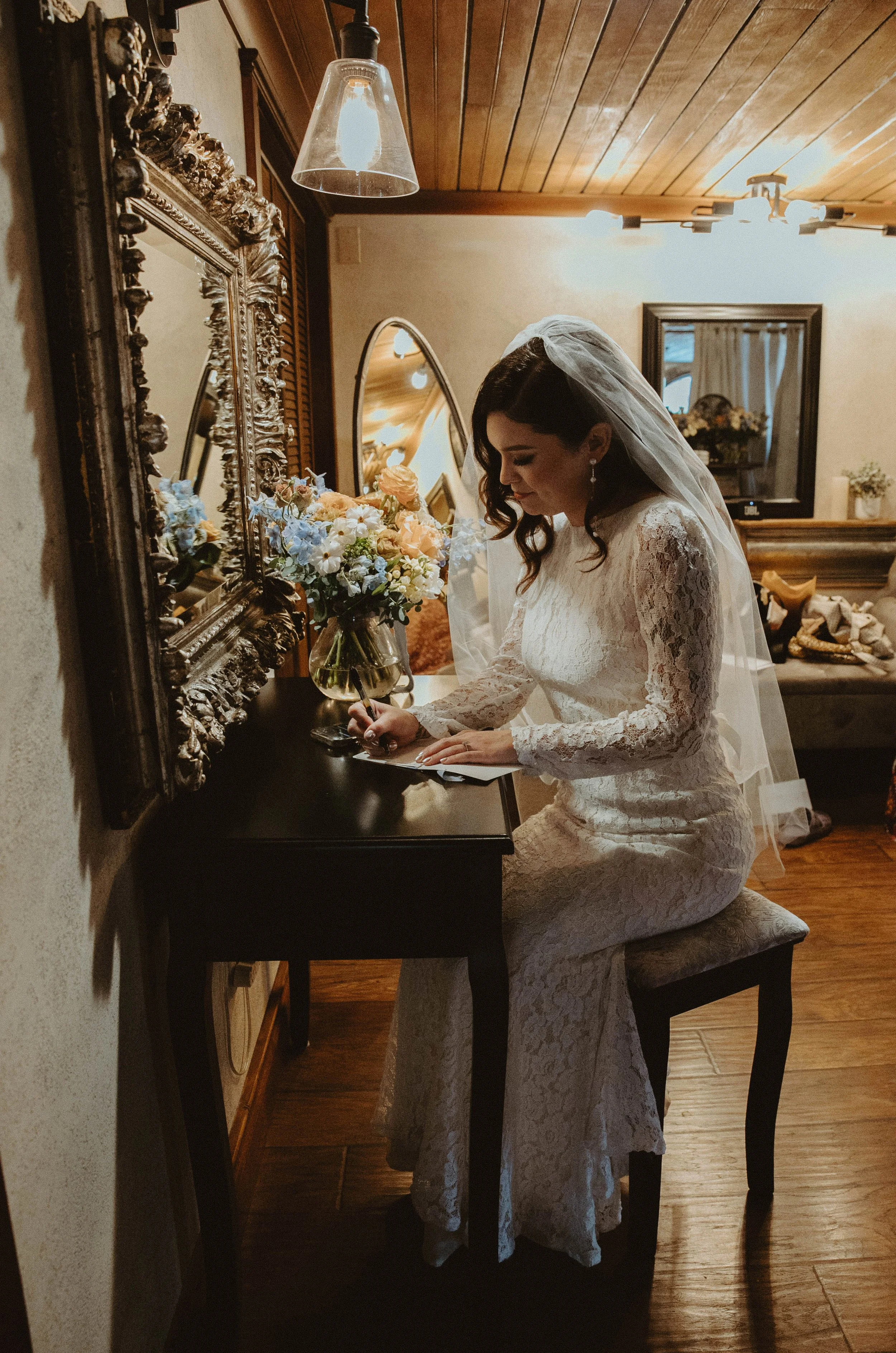 An image of a bride writing her vows in the bridal suite at StoneHouse101 Events Venue. StoneHouse101 is an intimate indoor outdoor events venue in Roslyn, Washington, hosting weddings, birthdays, anniversaries, and more near Cle Elum, WA.