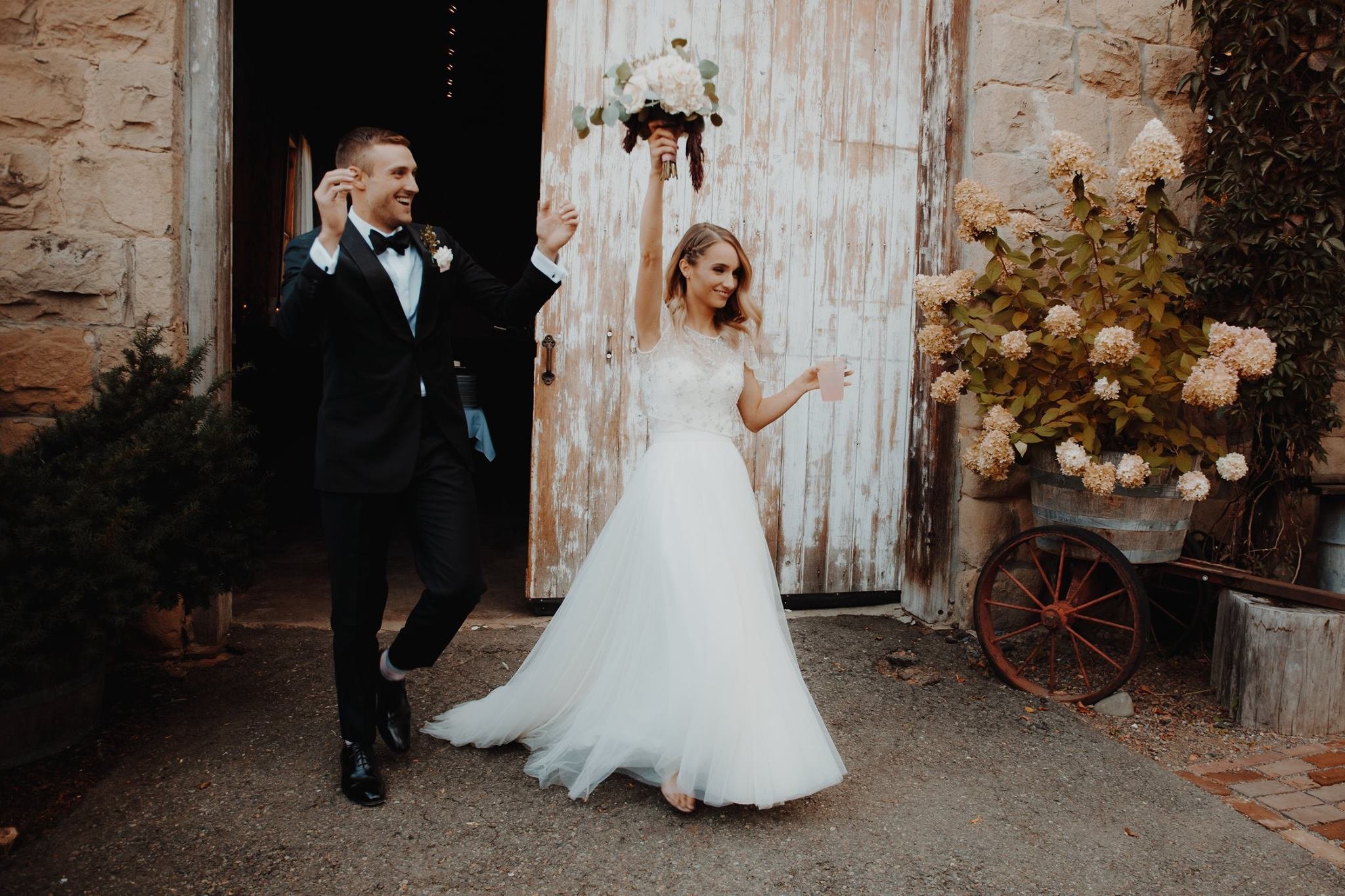 An image of a bride and groom entering their wedding reception at StoneHouse101. StoneHouse101 is an intimate indoor outdoor events venue in Roslyn, Washington, hosting weddings, birthdays, anniversaries, and more near Cle Elum, WA.