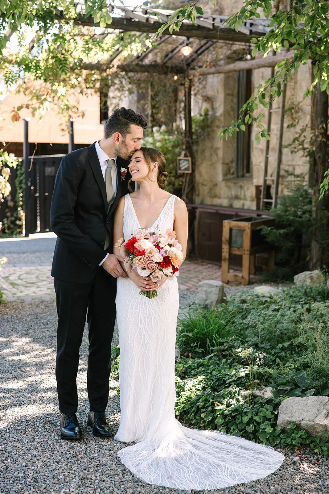 An image of a bride and groom posing outside of StoneHouse101. StoneHouse101 is an intimate indoor outdoor events venue in Roslyn, Washington, hosting weddings, birthdays, anniversaries, and more near Cle Elum, WA.