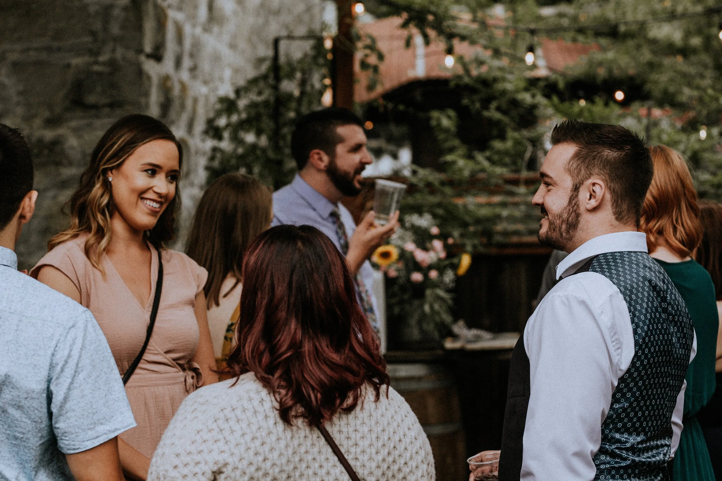 An image of guests smiling at a party at StoneHouse101 in Kittitas County. StoneHouse101 is an intimate indoor outdoor events venue in Roslyn, Washington, hosting weddings, birthdays, anniversaries, and more near Cle Elum, WA.