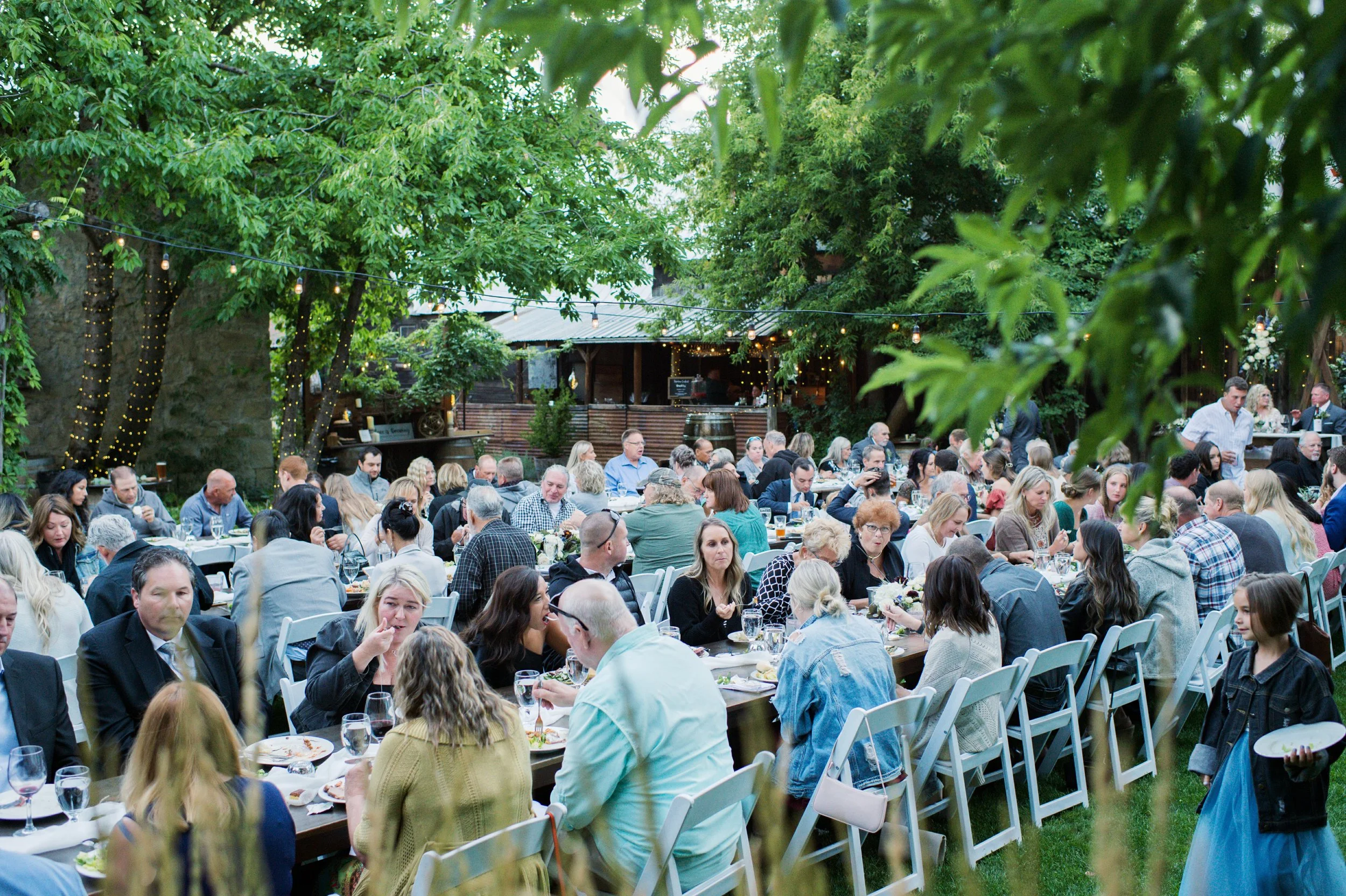 An image of an outdoor wedding dinner in Kittitas County at StoneHouse101. StoneHouse101 is an intimate indoor outdoor events venue in Roslyn, Washington, hosting weddings, birthdays, anniversaries, and more near Cle Elum, WA.