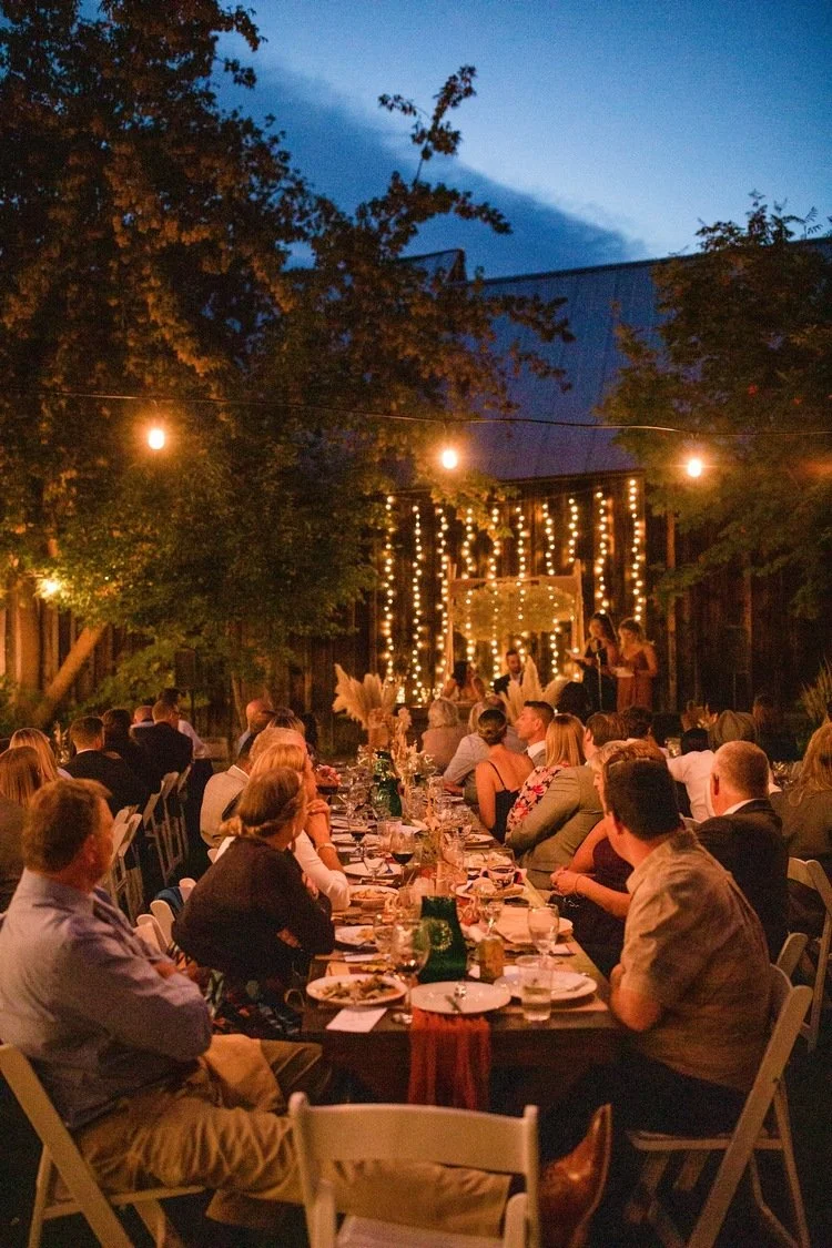 An image of guests at an outdoor evening event at StoneHouse101. StoneHouse101 is an intimate indoor outdoor events venue in Roslyn, Washington, hosting weddings, birthdays, anniversaries, and more near Cle Elum, WA.