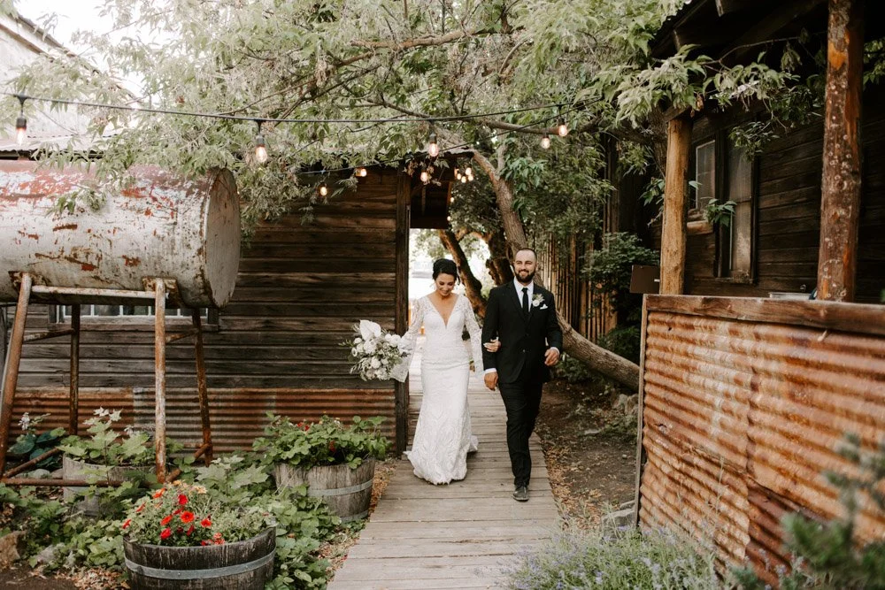 An image of a bride and groom entering their reception at StoneHouse101. StoneHouse101 is an intimate indoor outdoor events venue in Roslyn, Washington, hosting weddings, birthdays, anniversaries, and more near Cle Elum, WA.