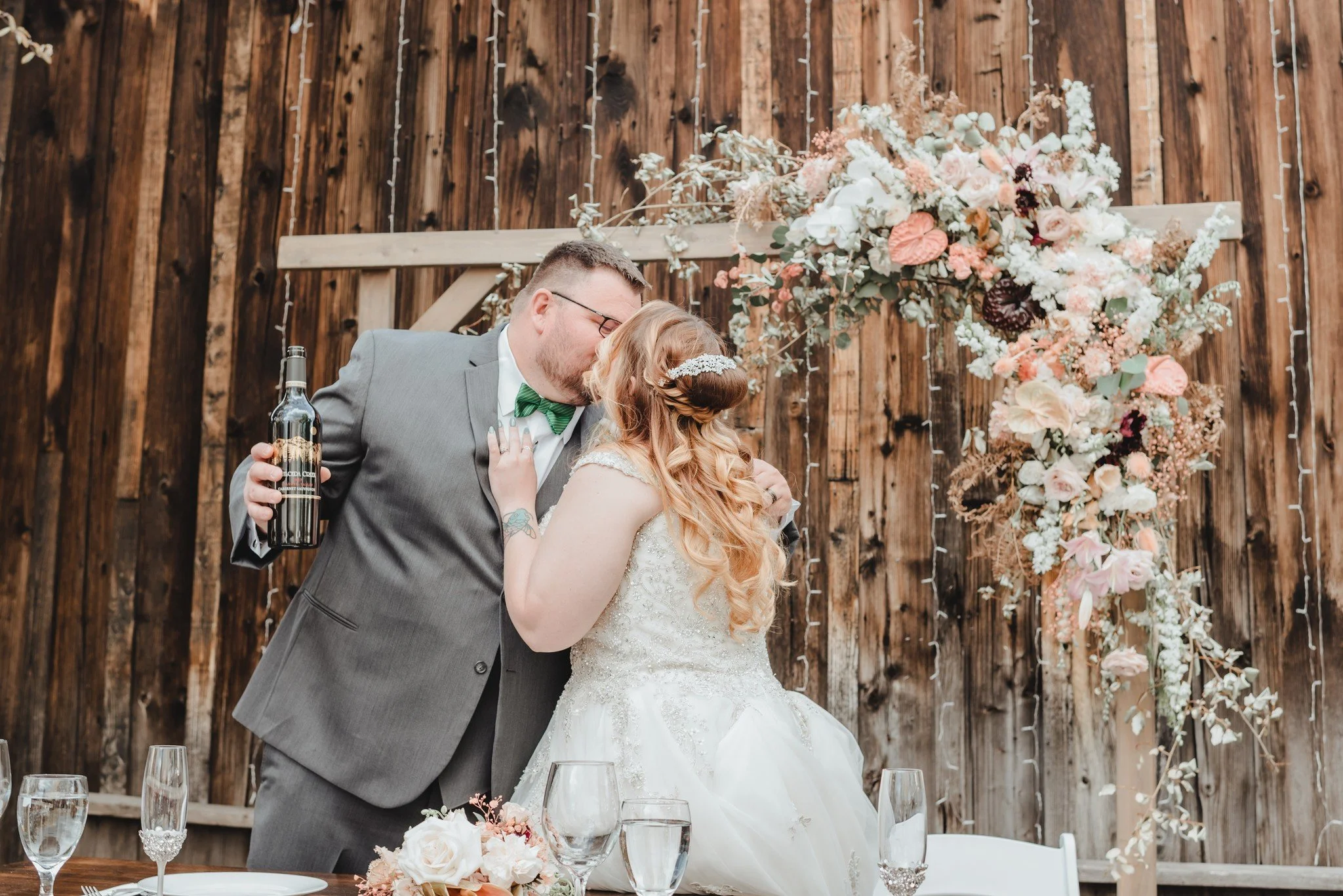 An image of a bride and groom celebrating their wedding at StoneHouse101. StoneHouse101 is an intimate indoor outdoor events venue in Roslyn, Washington, hosting weddings, birthdays, anniversaries, and more near Cle Elum, WA.