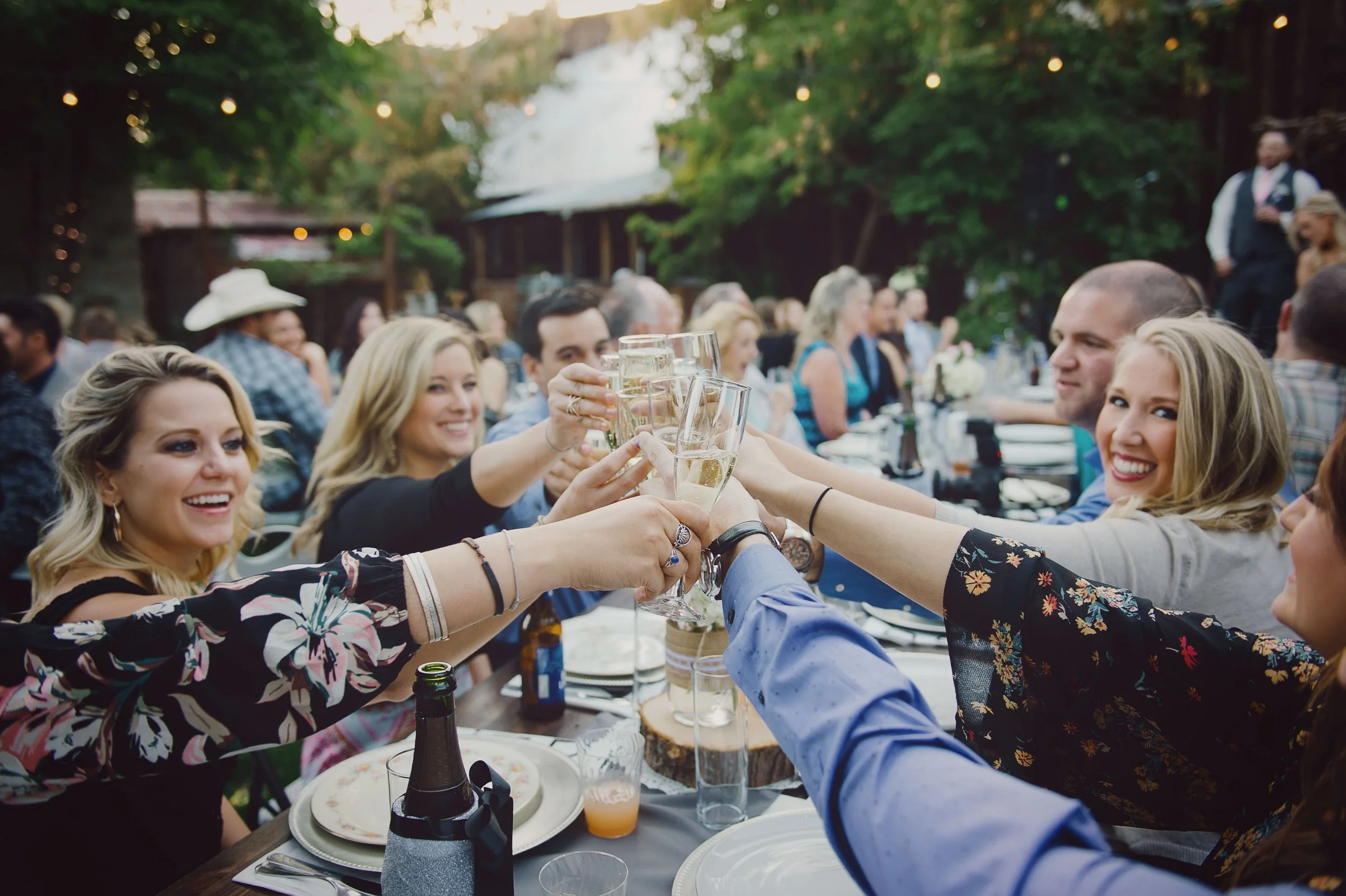 An image of event guests cheering at a dinner table at StoneHouse101 Events Venue in Roslyn, Washington. StoneHouse101 is a historic indoor outdoor events venue in Kittitas County, near Cle Elum and Ellensburg.