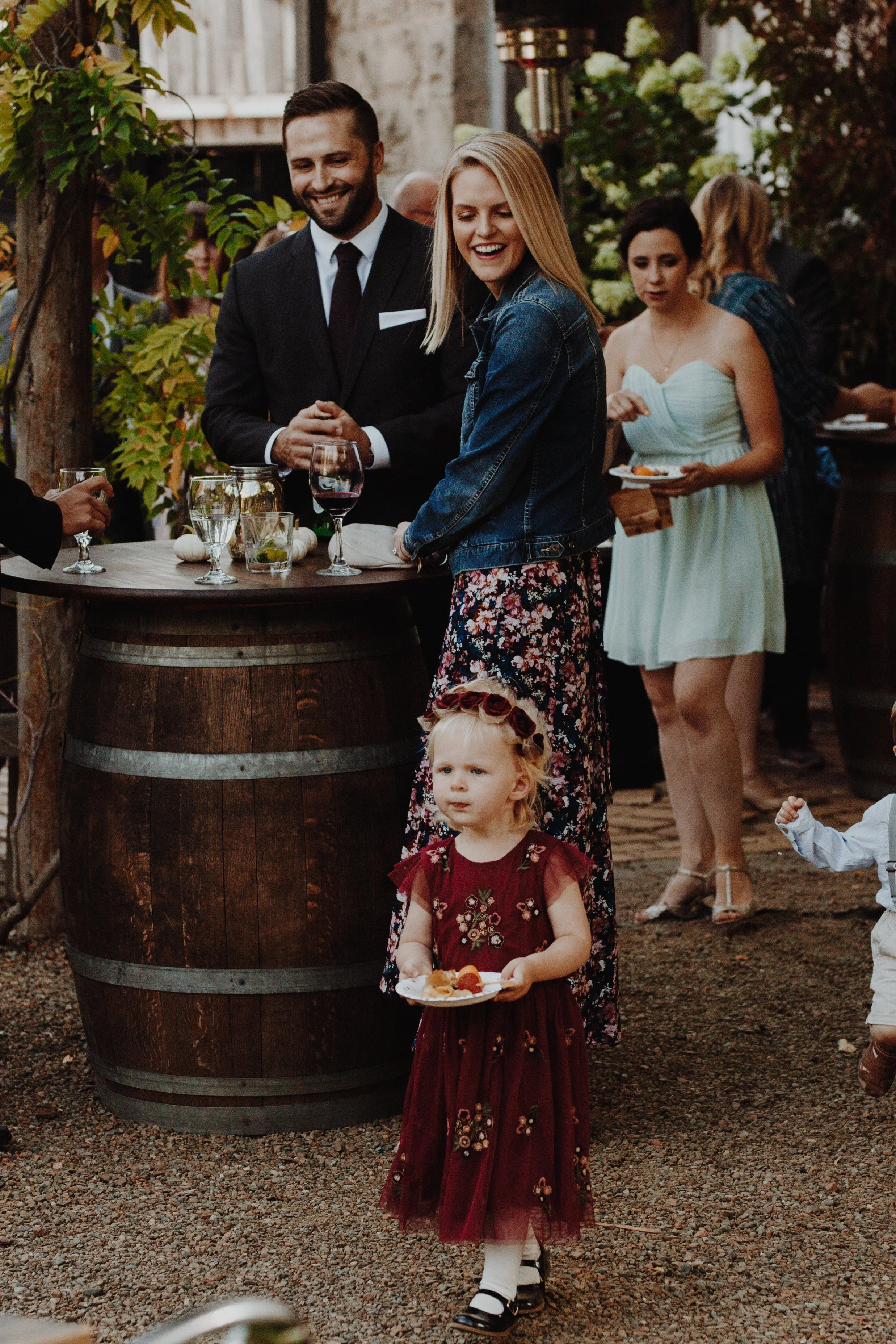 An image of guests smiling at a child at StoneHouse101. StoneHouse101 is an intimate indoor outdoor events venue in Roslyn, Washington, hosting weddings, birthdays, anniversaries, and more near Cle Elum, WA.