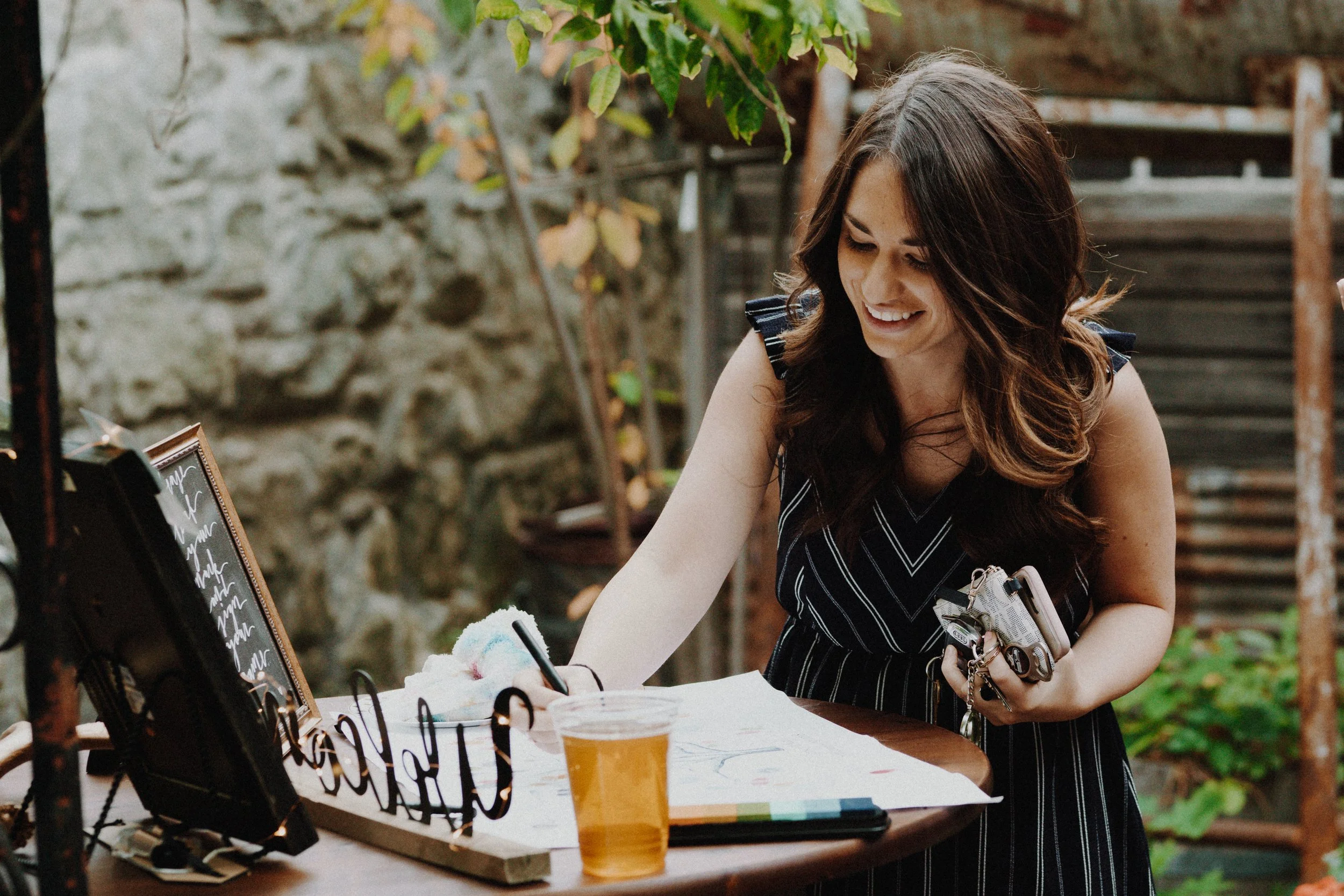 An image of someone writing in the guest book at a wedding at StoneHouse101. StoneHouse101 is an intimate indoor outdoor events venue in Roslyn, Washington, hosting weddings, birthdays, anniversaries, and more near Cle Elum, WA.