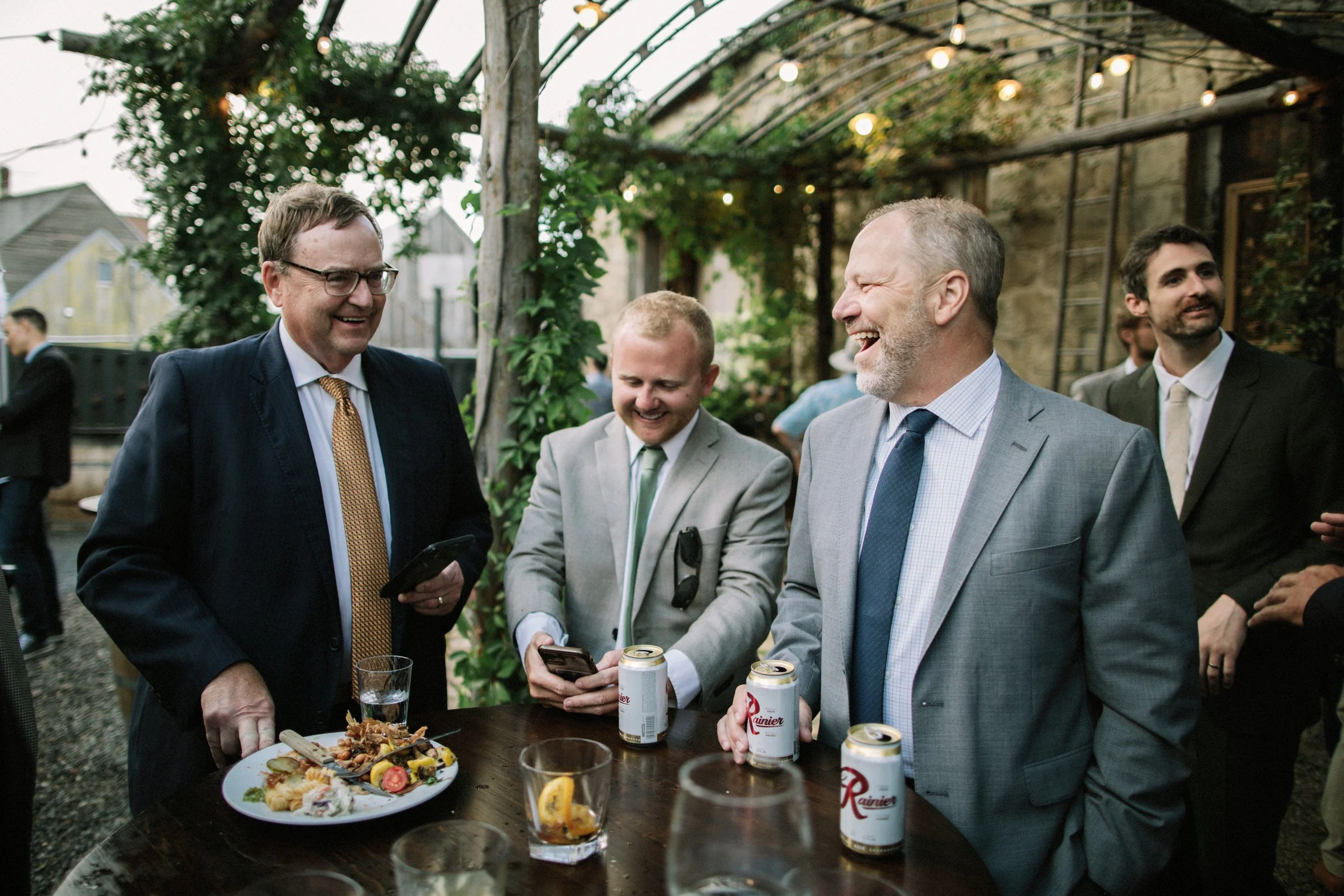 An image of guests smiling during a casual dinner at StoneHouse101. StoneHouse101 is an intimate indoor outdoor events venue in Roslyn, Washington, hosting weddings, birthdays, anniversaries, and more near Cle Elum, WA.