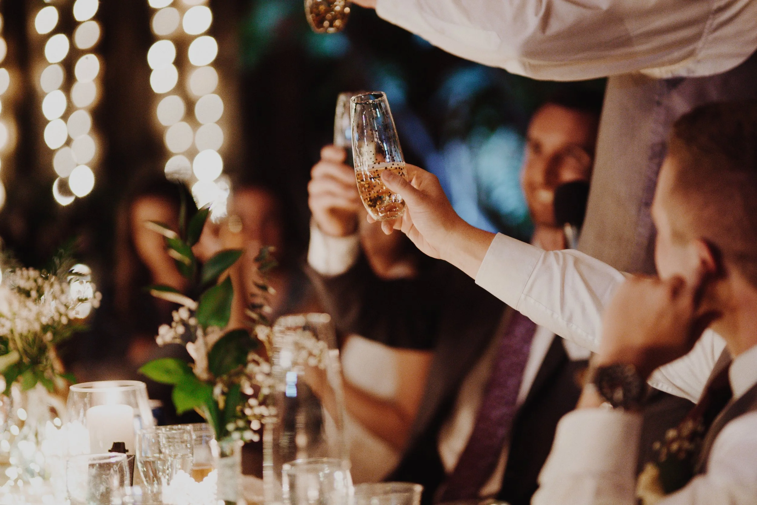 An image of guests saying "cheers" at a party at StoneHouse101. StoneHouse101 is an intimate indoor outdoor events venue in Roslyn, Washington, hosting weddings, birthdays, anniversaries, and more near Cle Elum, WA.