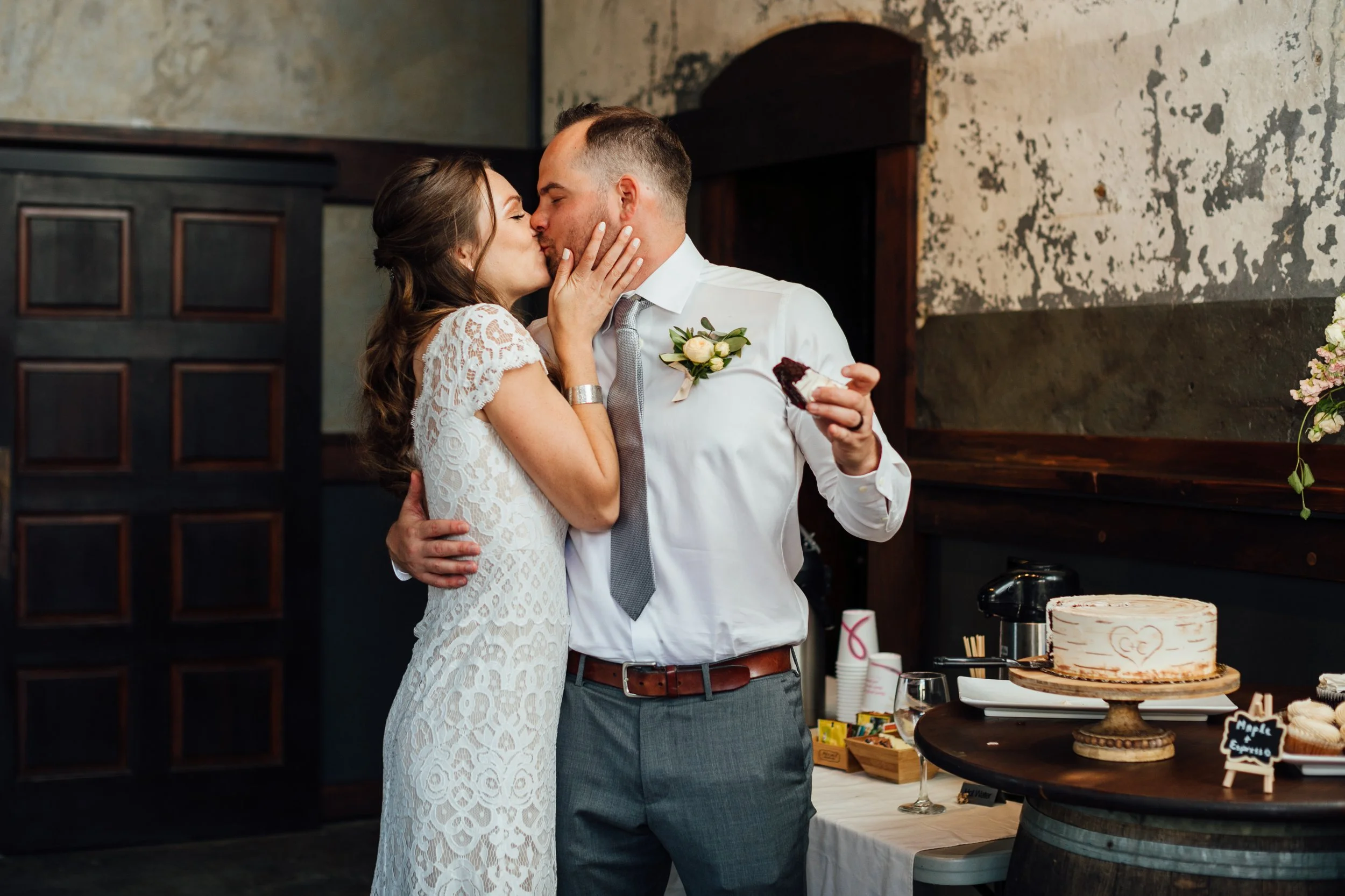 An image of a bride and groom cutting their cake at their indoor wedding venue in Kittitas County. StoneHouse101 is an intimate indoor outdoor events venue in Roslyn, Washington, hosting weddings, birthdays, anniversaries, and more near Cle Elum, WA.