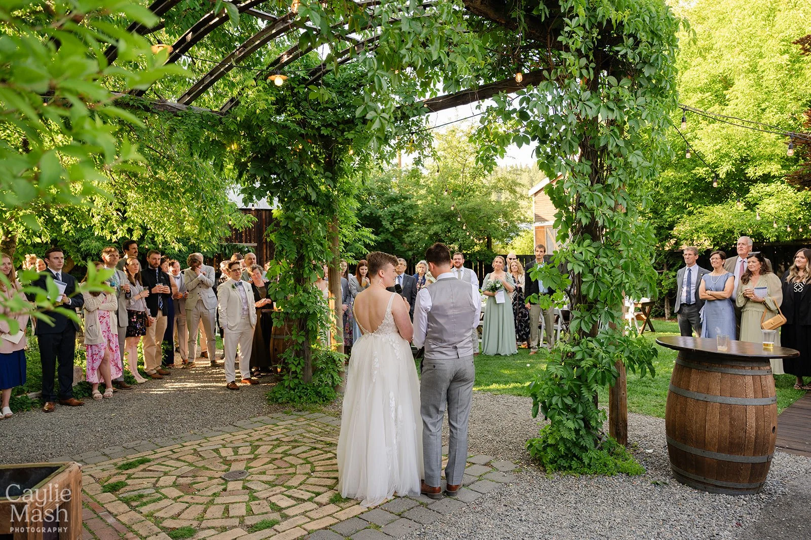 An image of a bride and groom welcoming guests to their outdoor wedding at StoneHouse101. StoneHouse101 is an intimate indoor outdoor events venue in Roslyn, Washington, hosting weddings, birthdays, anniversaries, and more near Cle Elum, WA.