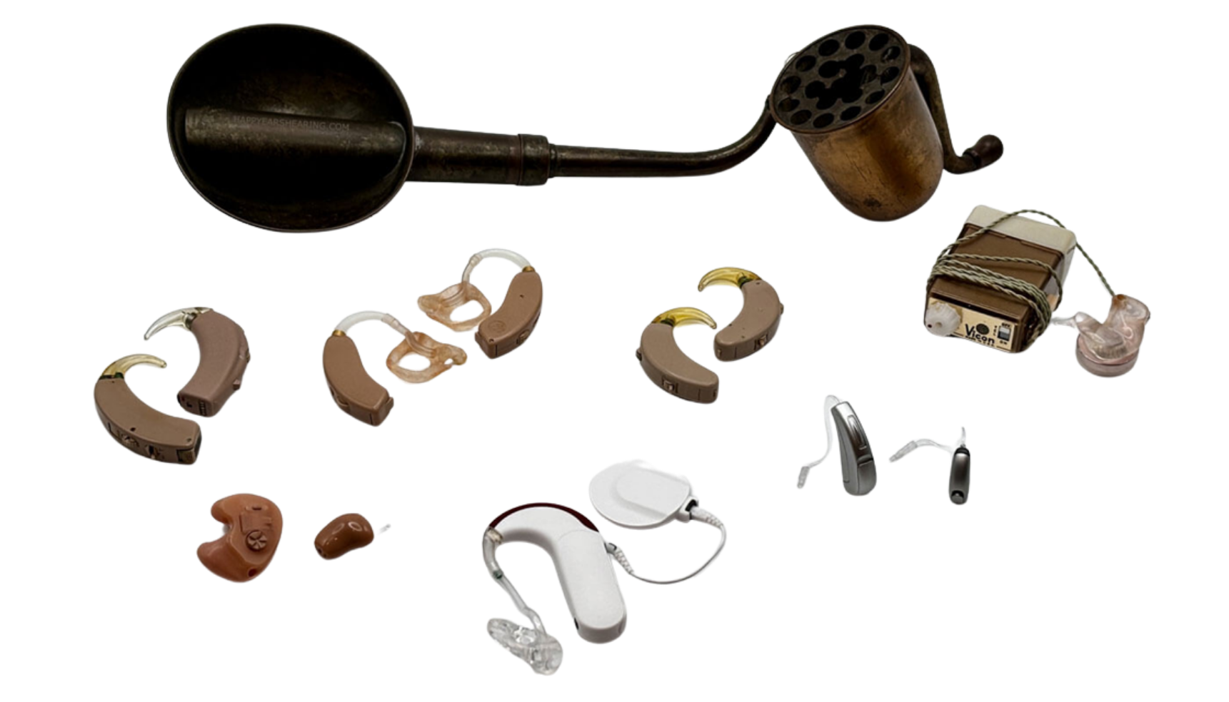 Collection of hearing aids, a hearing aid battery, and a hearing aid cleaning tool on a clear surface.