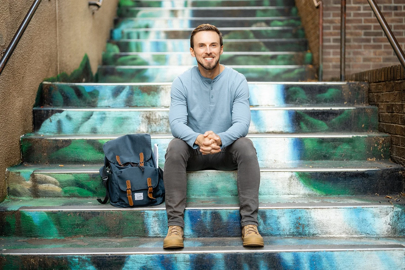 Man sitting outside on cement steps