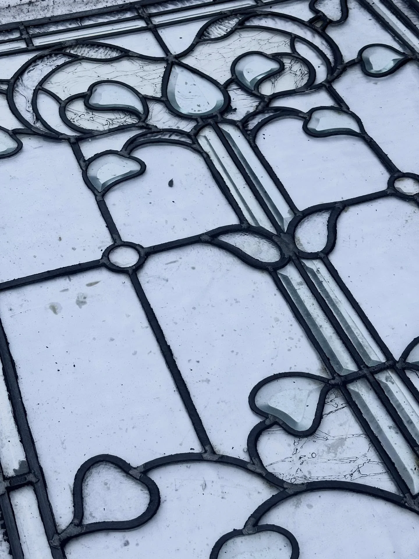 When this beautiful 35x28 leaded window came to me from a Rosedale home, several glass pieces were cracked in tricky spots, the steel reinforcement bar had completely separated from the window and took the lead with it, making the window structurally