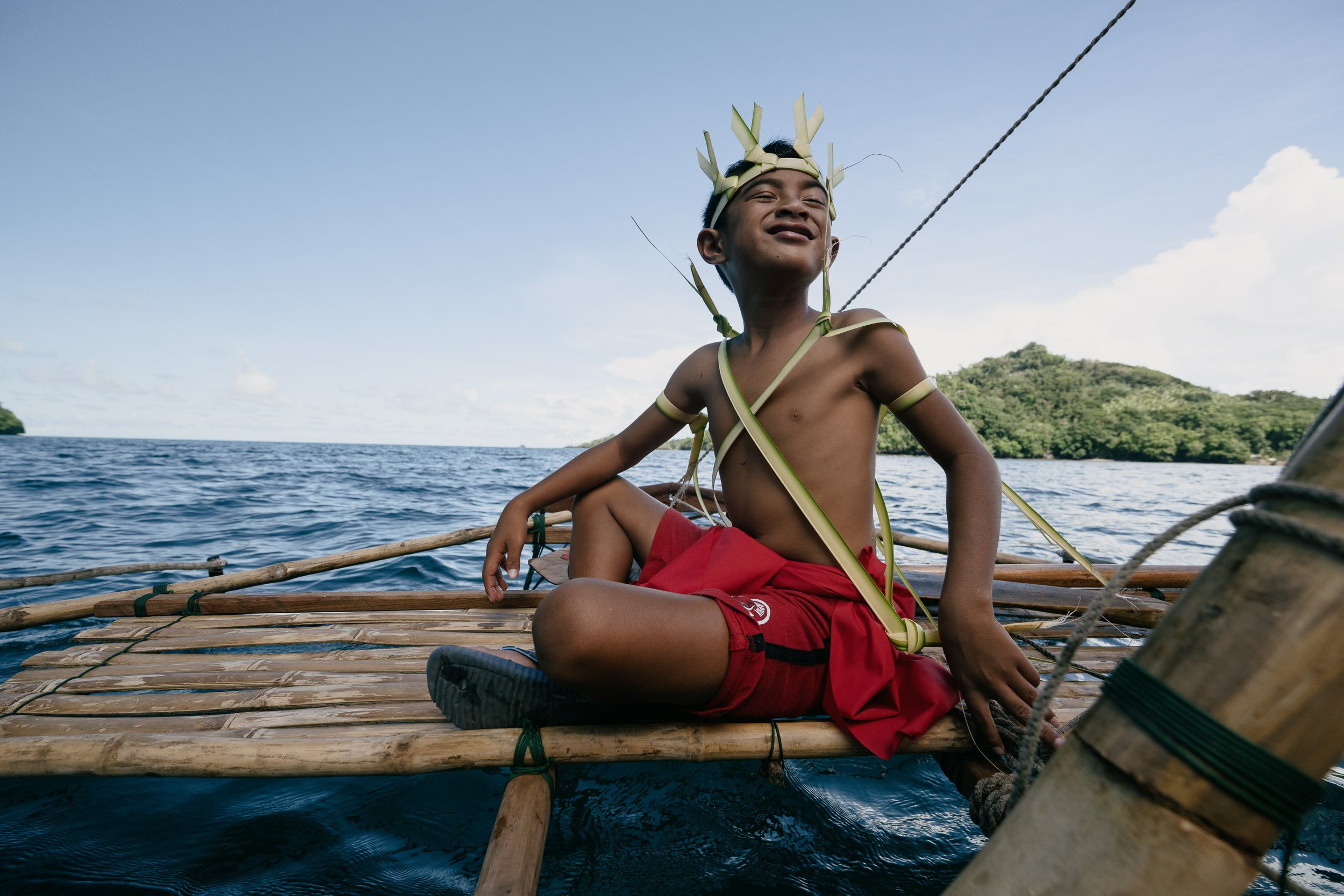  Young navigator Walter Andrew relaxes aboard a Palaun Southwest Islander outrigger canoe. The arts of traditional navigation and fishing are revived to Palau, as more young people embrace the Indigenous systems that keep their fisheries and liveliho