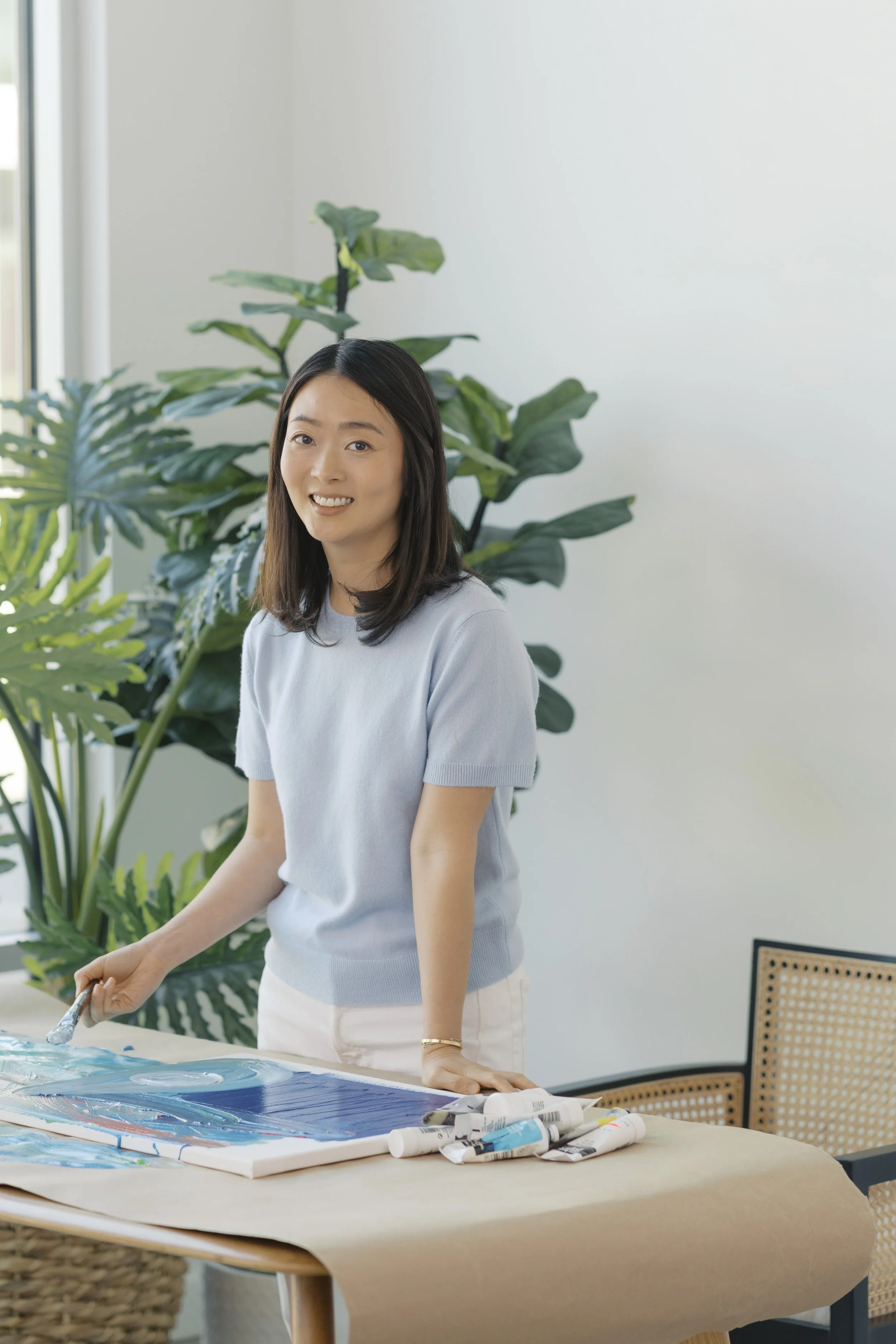 Smiling Juhee adds final details to her artwork during a session focused on inner mothering and emotional healing.
