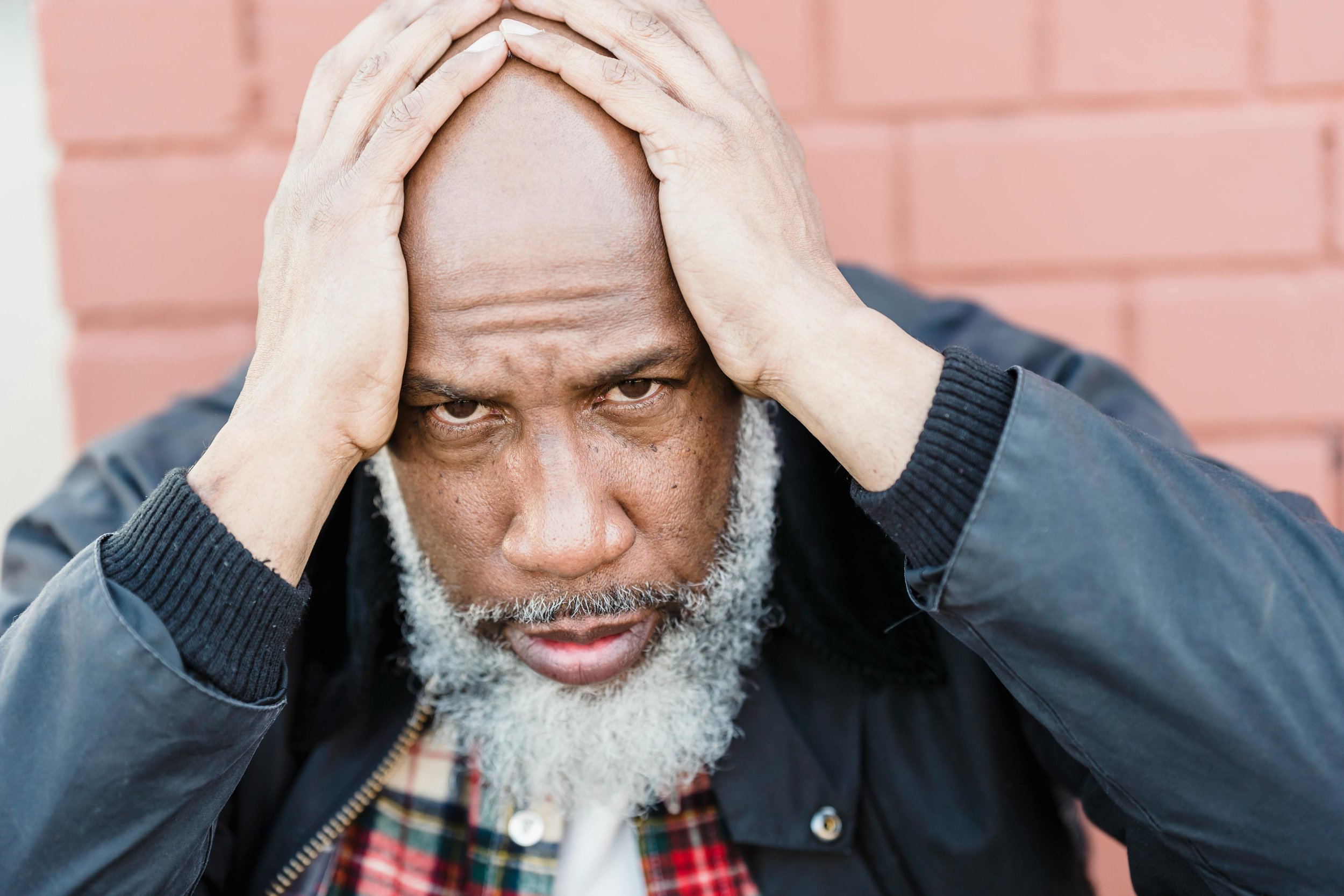 man holding head in hands