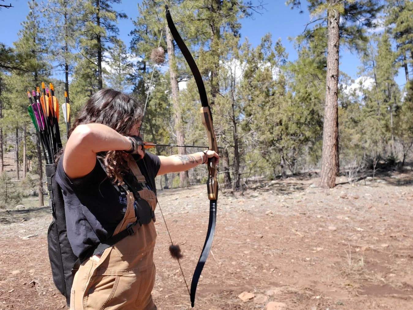 Woman shooting a bow and arrow