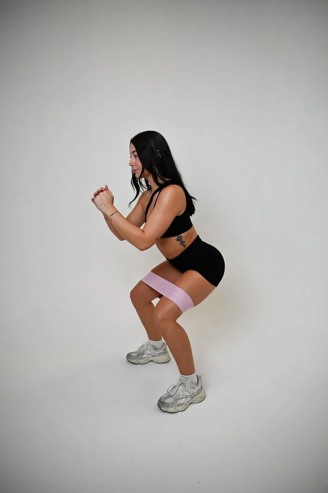 Paris demonstrating a banded squat