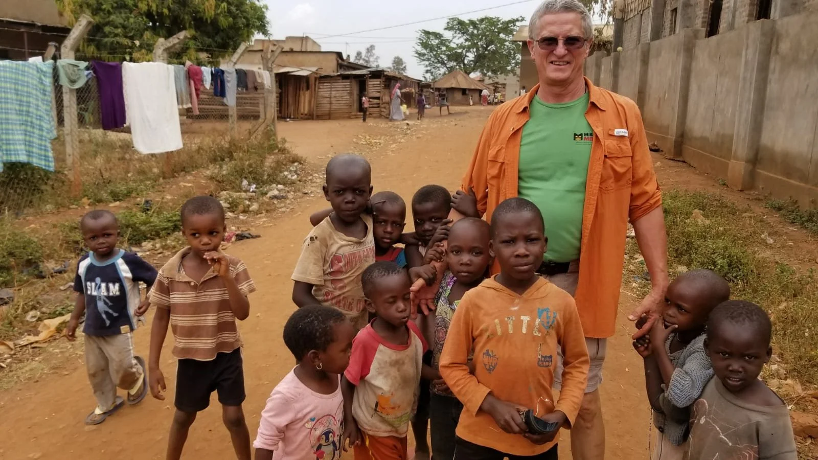 One of our founding members surrounded by Ugandan children.
