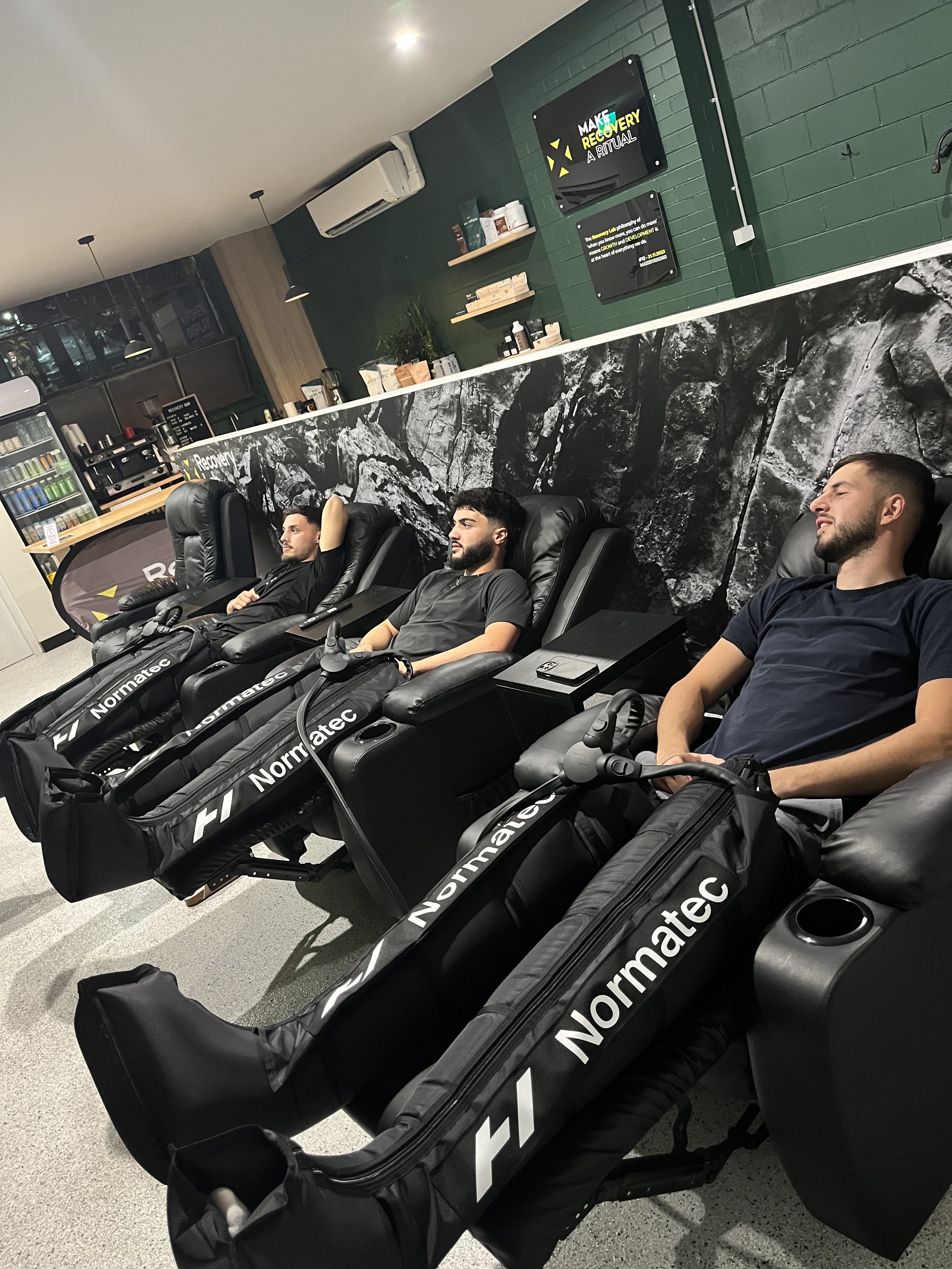 Compression therapy chairs in the recovery lounge at Recovery Lab Maribyrnong, designed for relaxation and muscle recovery.