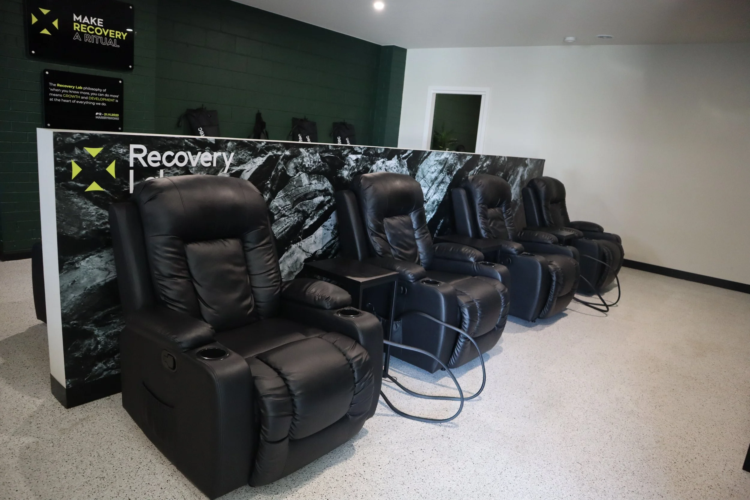 Compression therapy lounge at Recovery Lab Maribyrnong featuring multiple recovery chairs in a calm, shared space.