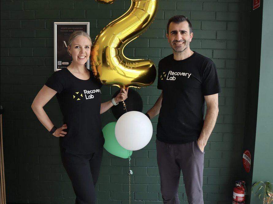 Owners of Recovery Lab Maribyrnong standing inside the studio, celebrating the business milestone and welcoming the local community.