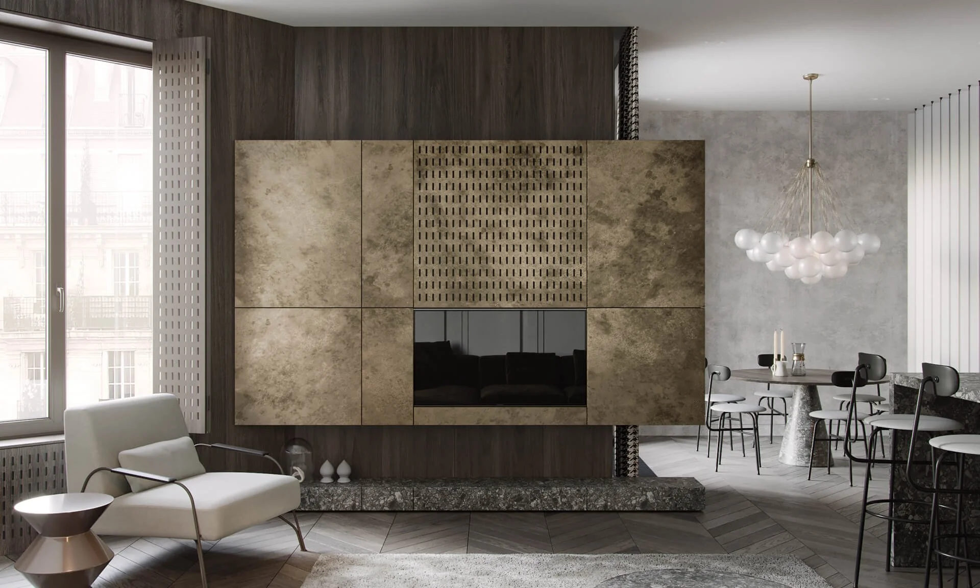 Modern interior living room featuring a white armchair with cushion, a small metallic side table, a large window, textured wall paneling with a fireplace or TV, a dining table with four chairs, a contemporary chandelier, and a gray wood and stone flooring.