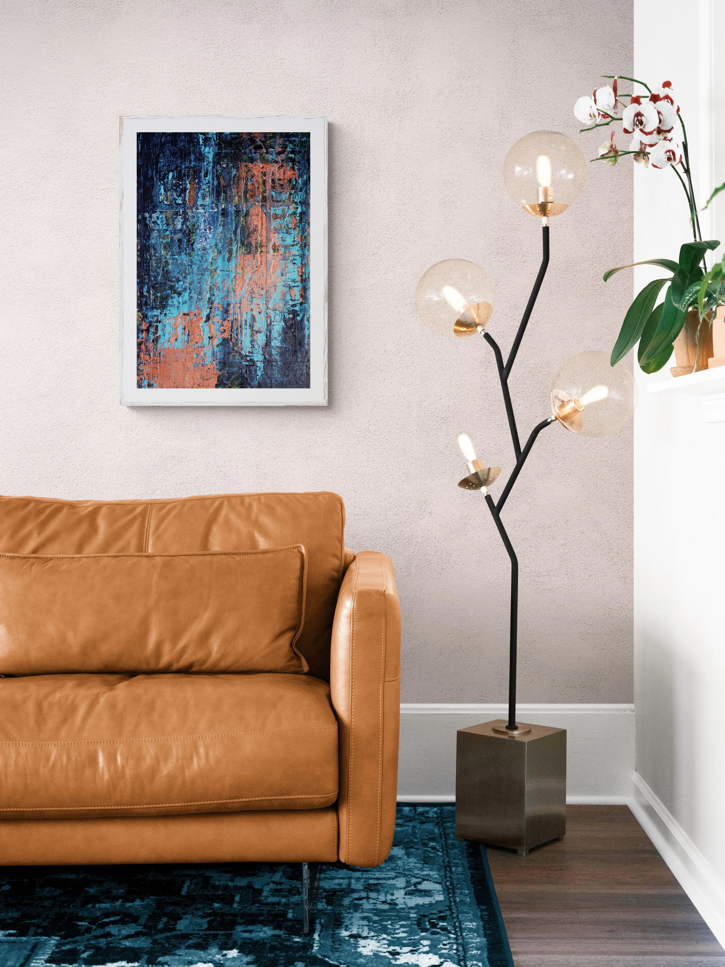 Abstract mixed media collage artwork by Virginie Hotte displayed in a modern living room above a brown leather sofa.
