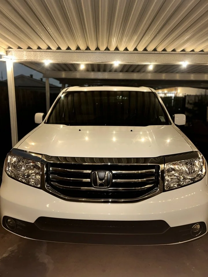 Front view of a white Honda SUV after an exterior mobile detail done by Pro-Purple Mobile Detailing in Kenner, Louisiana. 