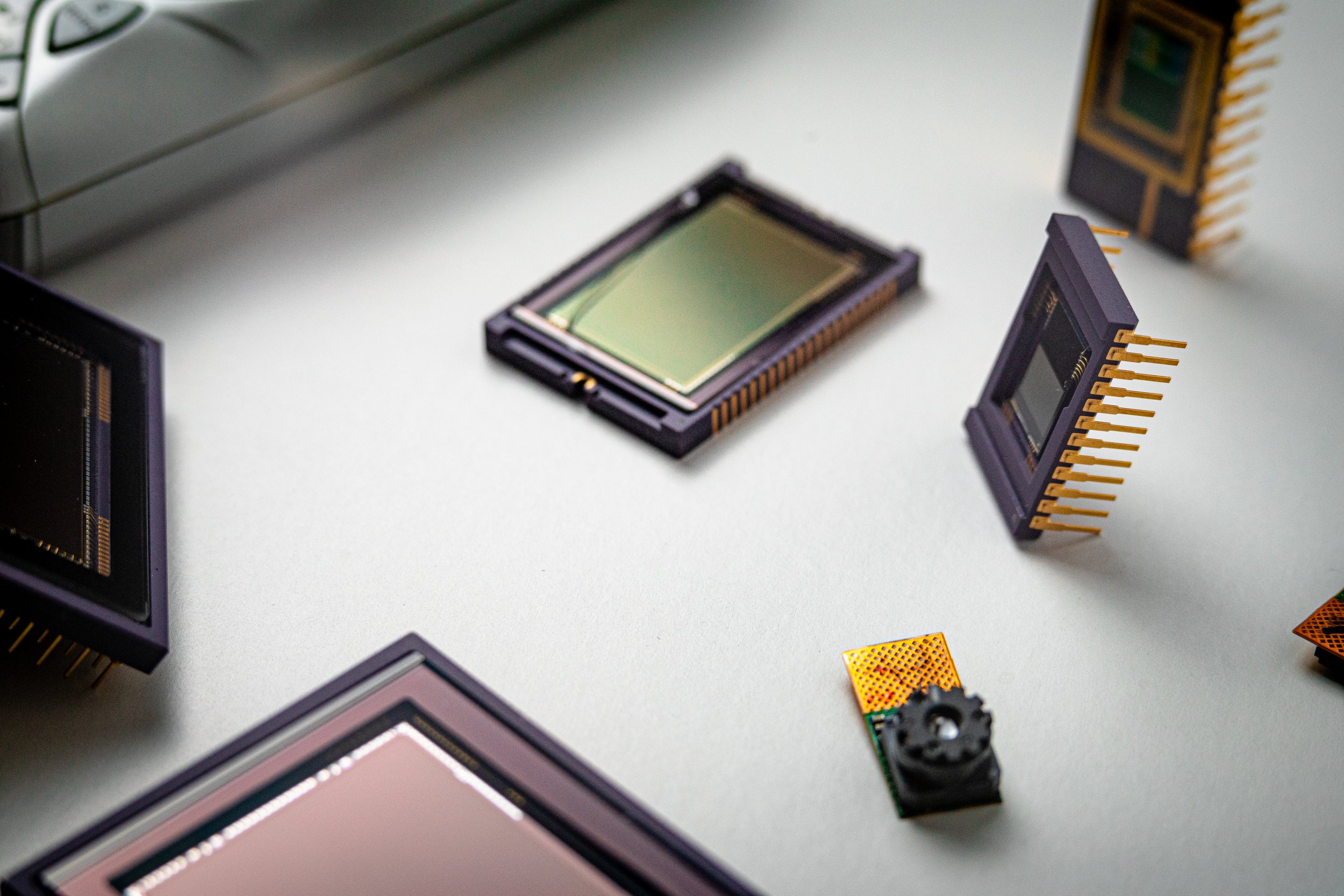 Various computer processor chips and integrated circuits on a white surface.