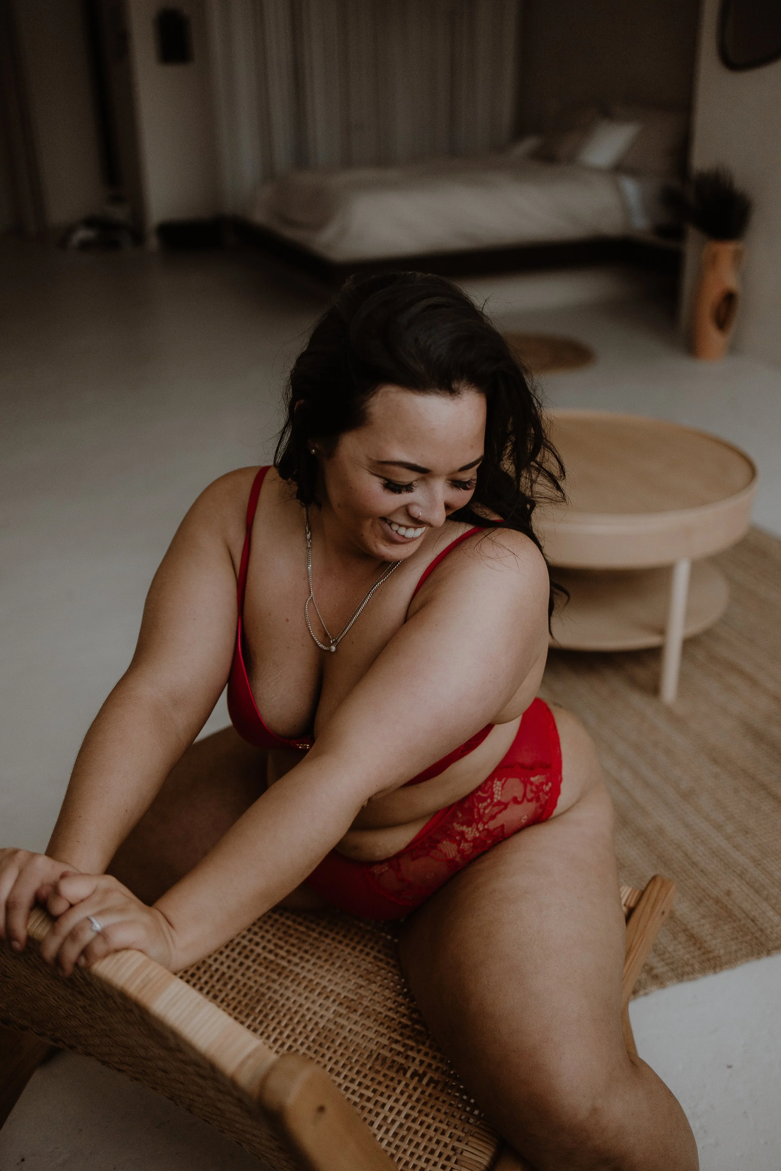 Cozy boudoir photography session in Brantford featuring a woman in a soft, intimate bedroom setting.