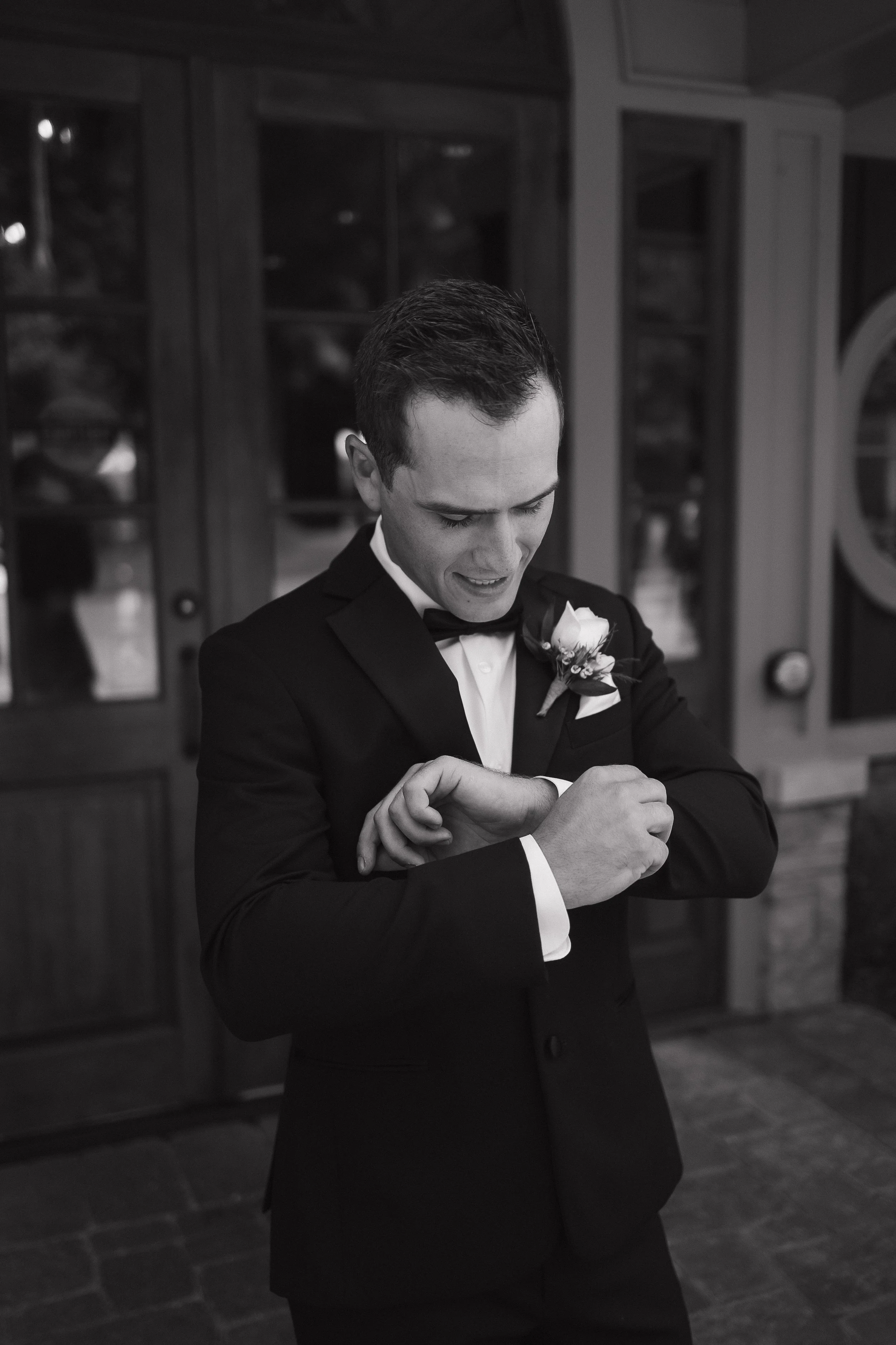 groom adjusting cuff links, Ontario wedding photography by James and Alyson Photography