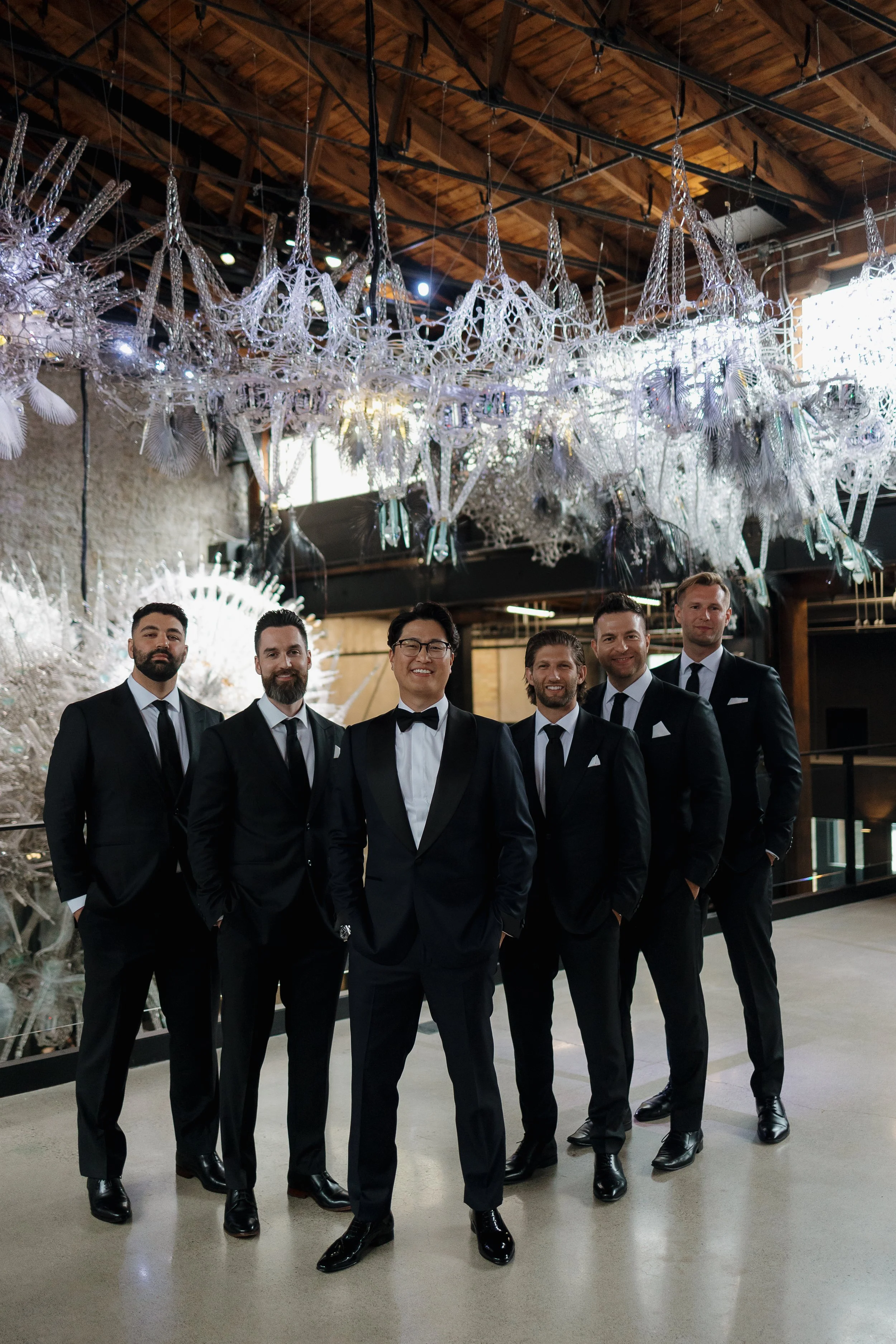 Groom and groomsmen smiling, photographed by James and Alyson Photo