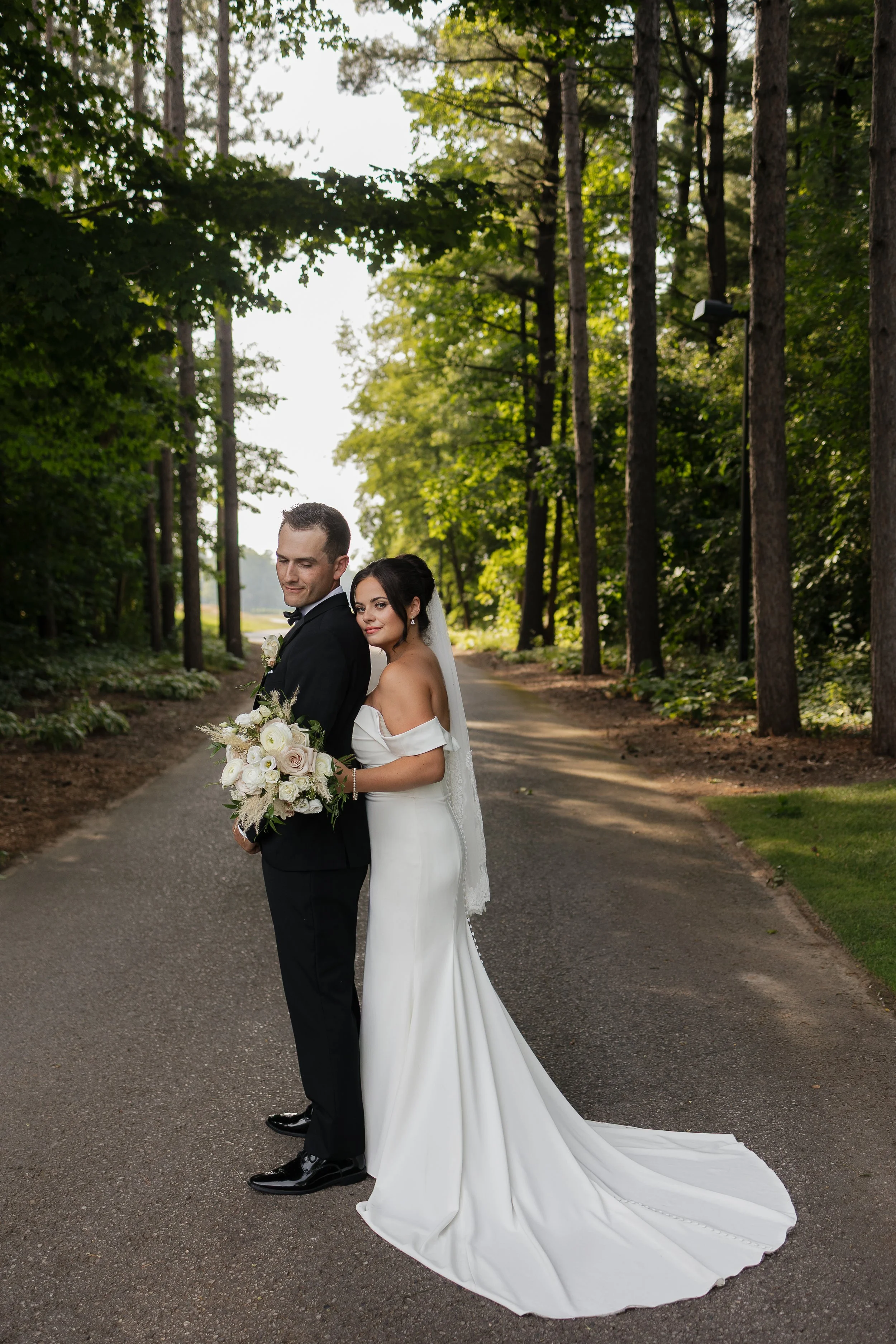bride hugging the groom from behind, Ontario wedding photography by James and Alyson Photography