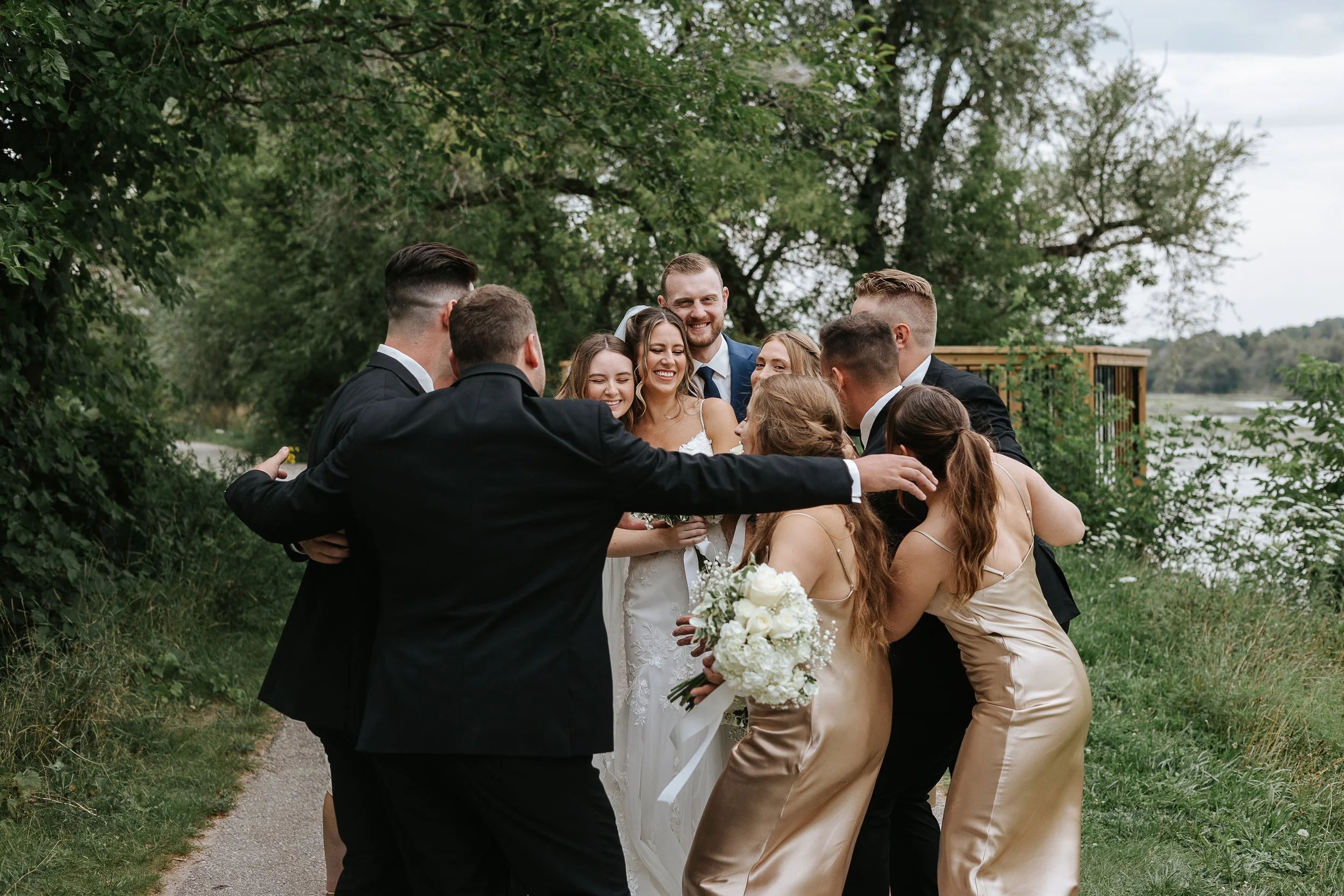 Wedding party hugging at a Storehouse 408 wedding in Cambridge Ontario