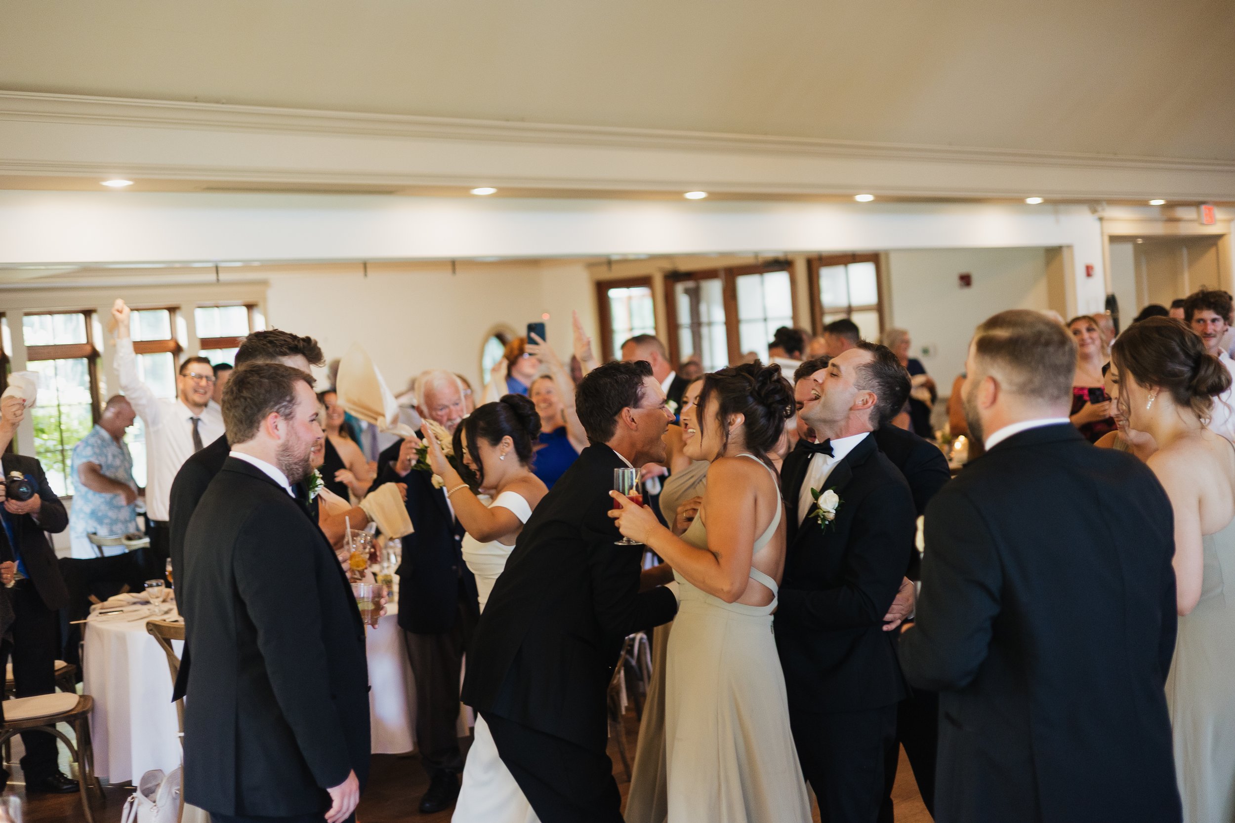 wedding party dancing together during grand entrance, Ontario wedding photography by James and Alyson Photography