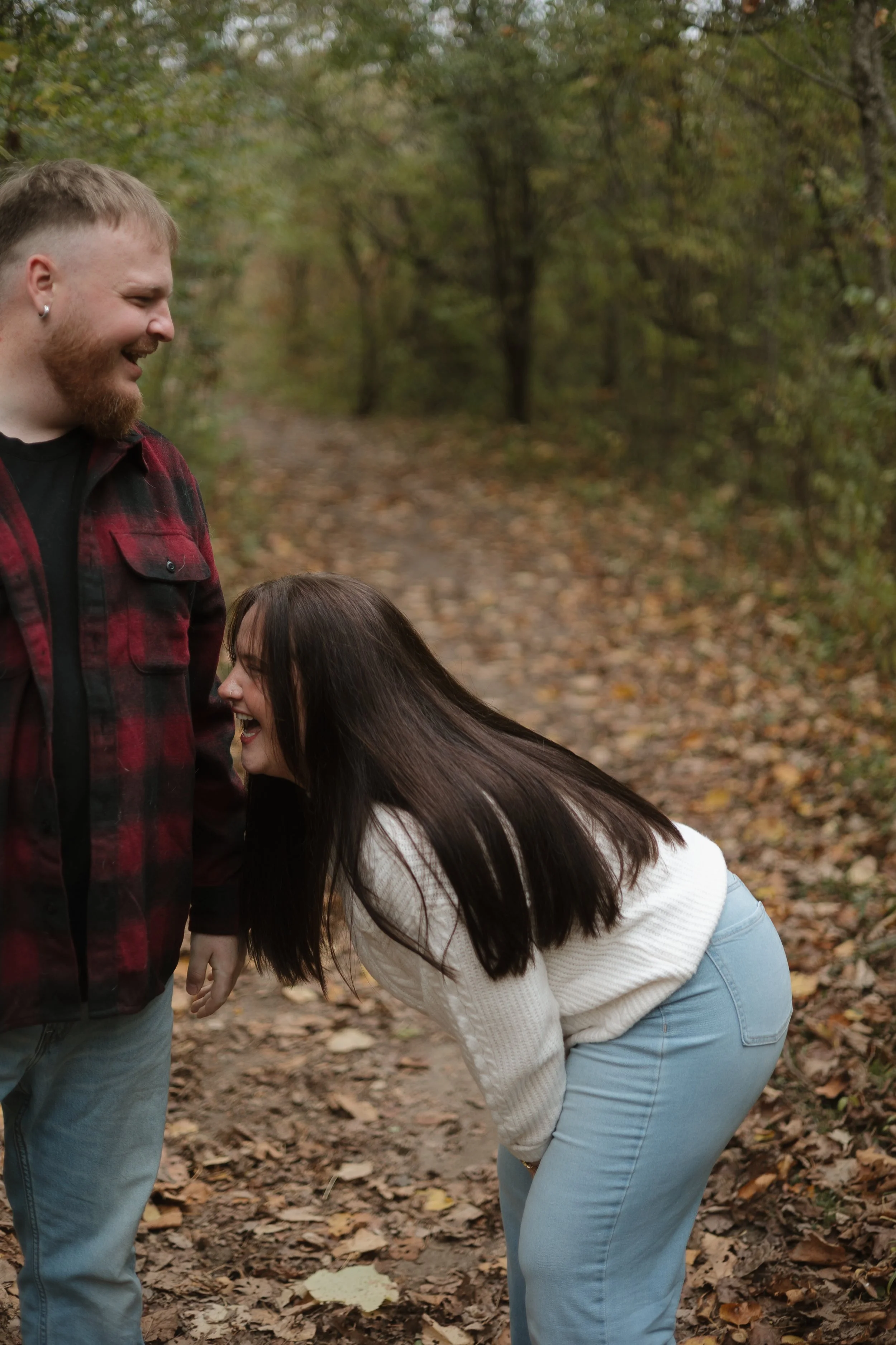 Candid laughter from an engaged couple during a photoshoot at Penmans Pass in Paris Ontario