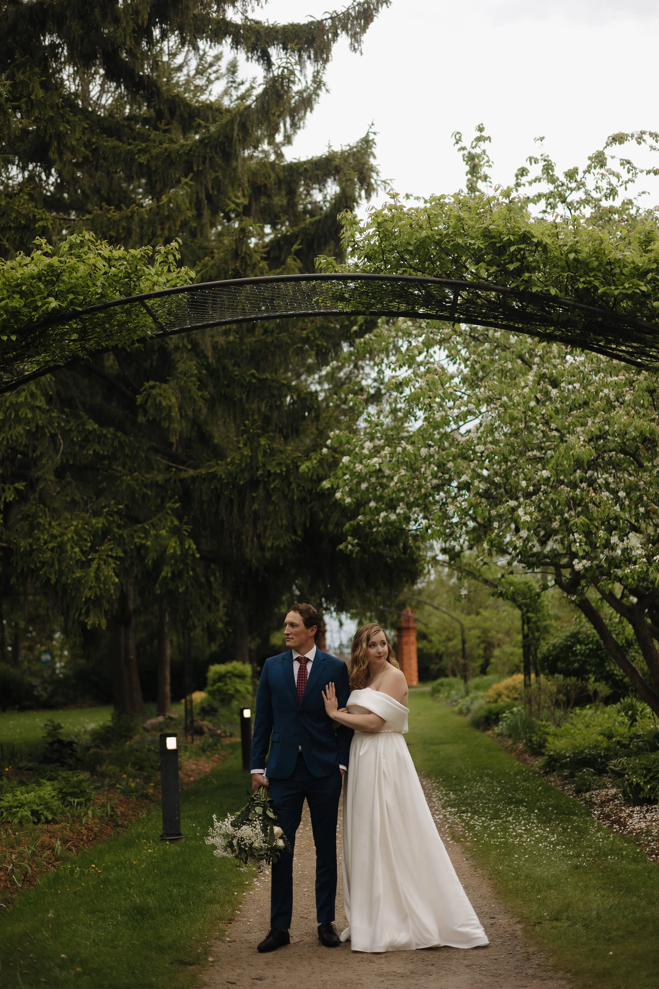 Bride and groom under flowers, Guild Inn Estate wedding, Ontario wedding photography by James and Alyson Photography