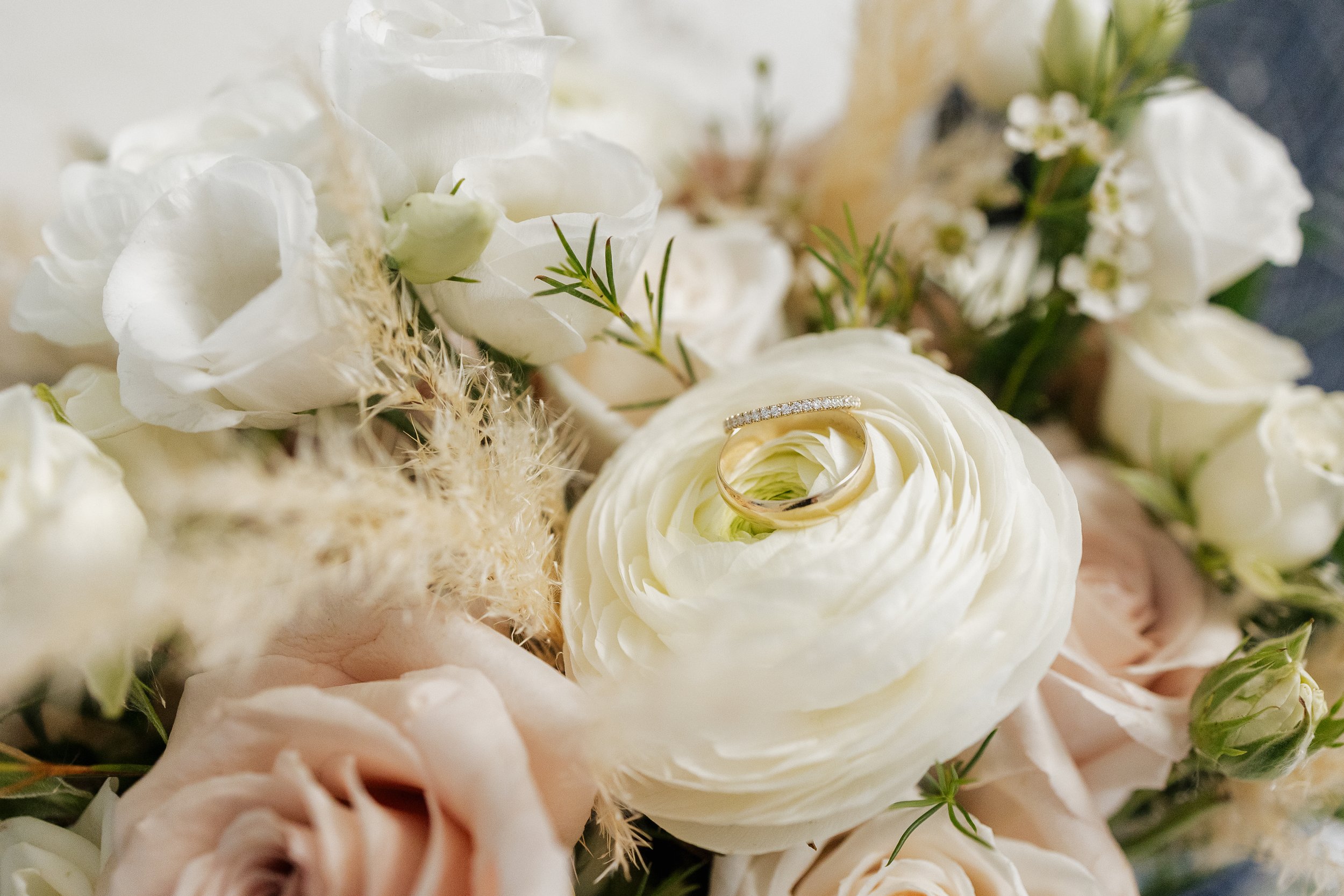 detail shot of rings in the bridal bouquet, Ontario wedding photography by James and Alyson Photography