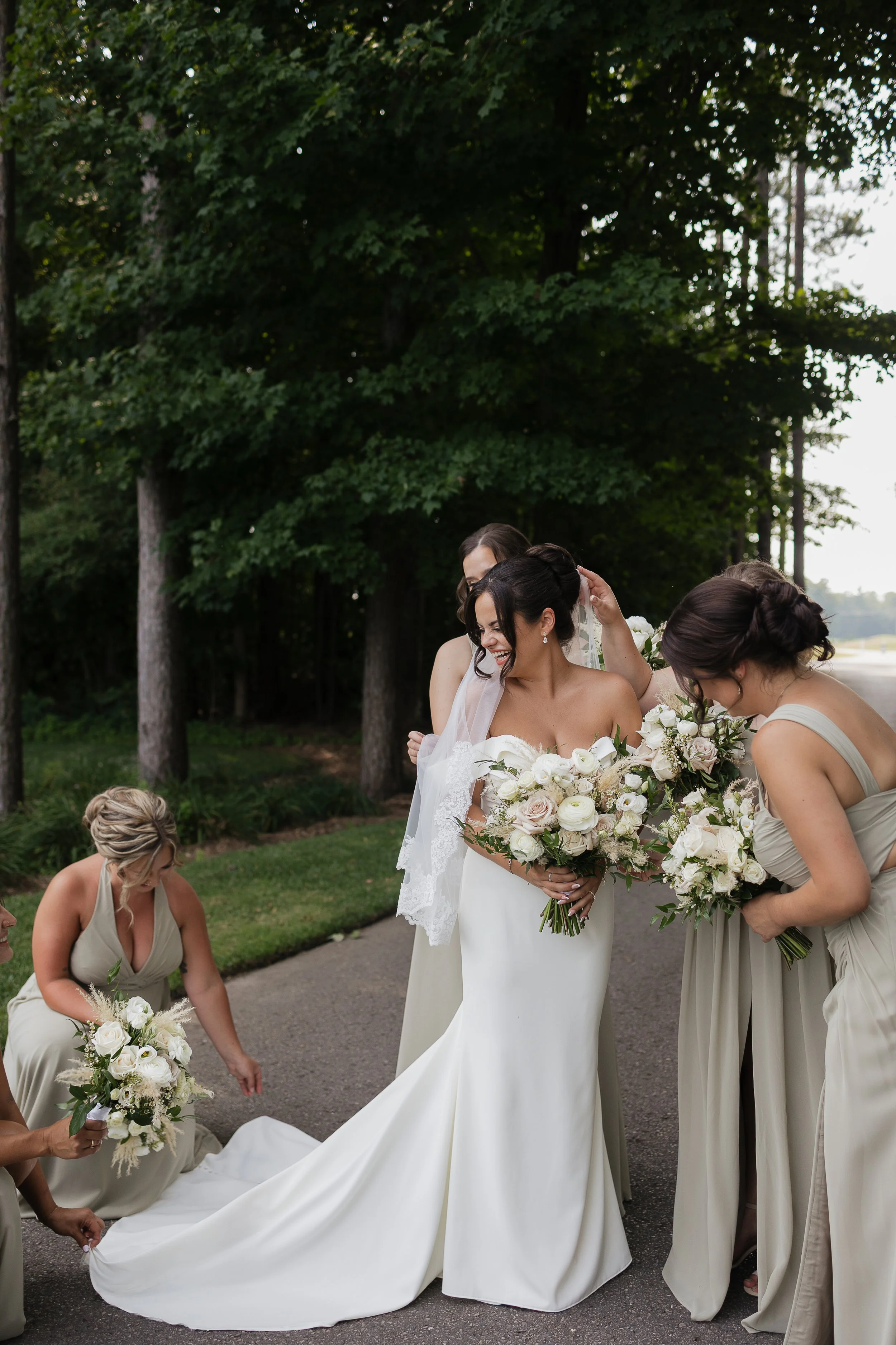 bridal party fluffing brides train, Ontario wedding photography by James and Alyson Photography
