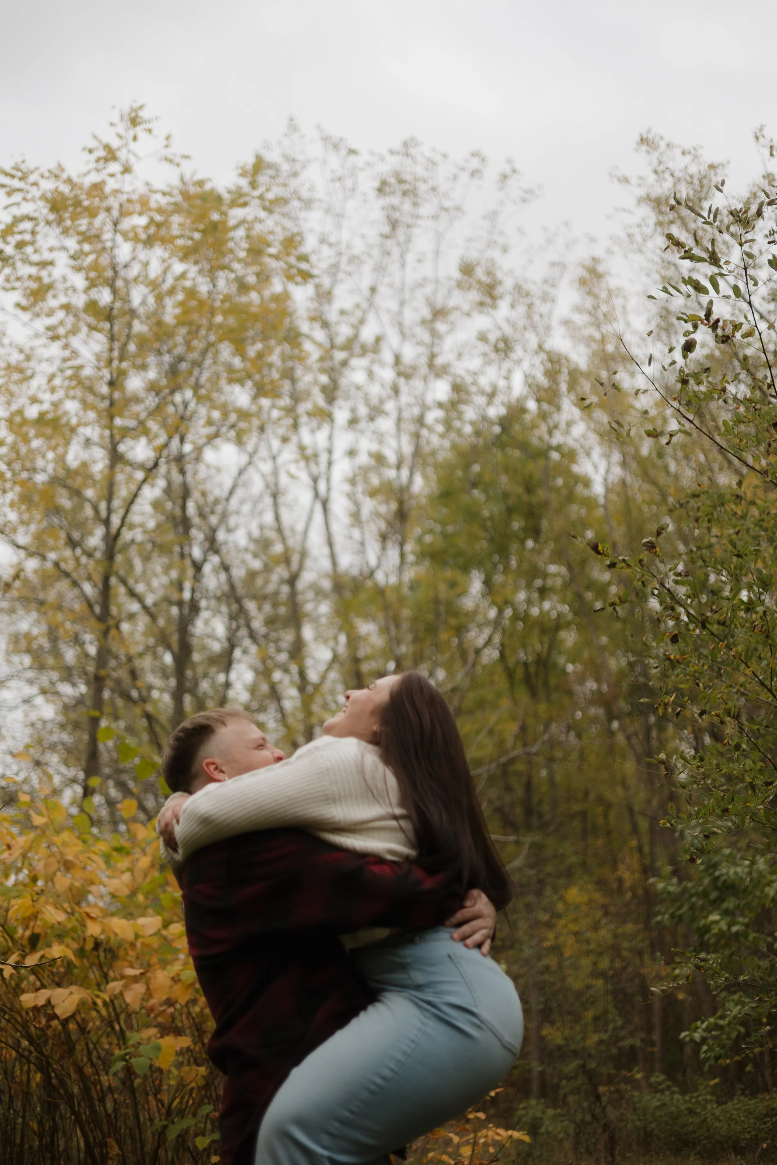 Playful fall engagement session in Paris Ontario at Penman’s Pass with natural laughter