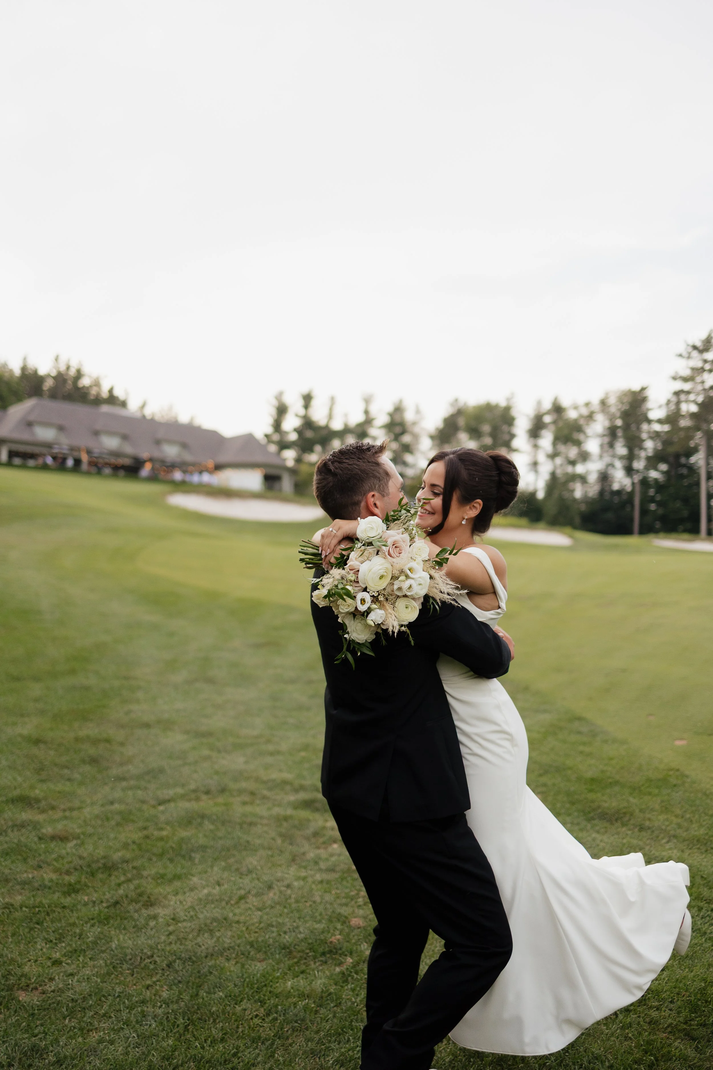 groom picking up the bride, ontario wedding photography by james and alyson photo