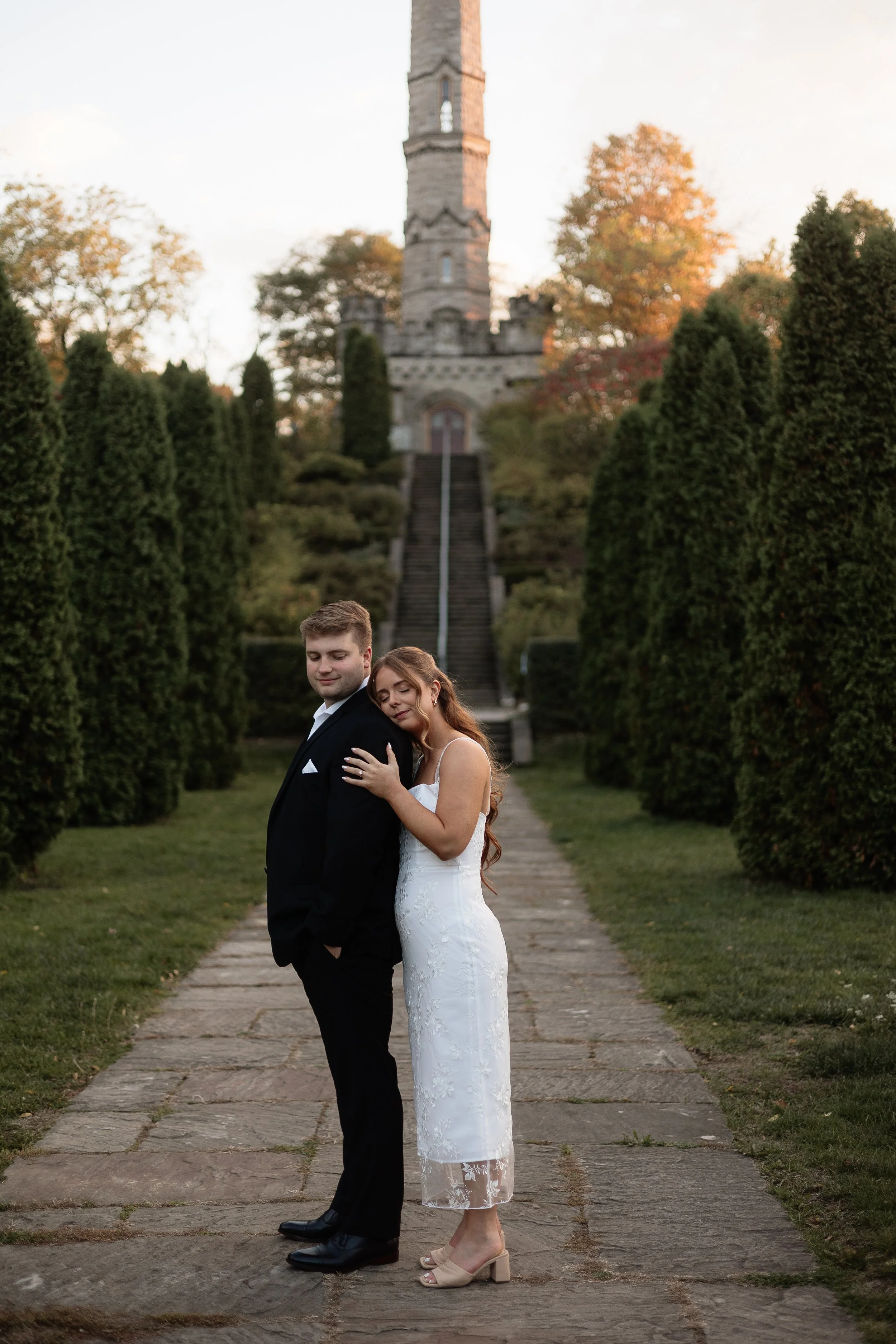 Engaged couple sharing a quiet moment at Battlefield House and Museum in Hamilton, Ontario